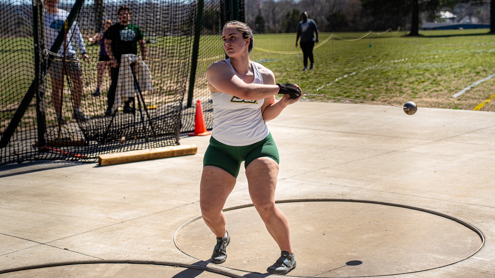 Missouri S&T thrower Sydney Morris rotates through a hammer throw attempt inside the circle during the Miner Invitational, with the weight extended outward as she prepares to release.