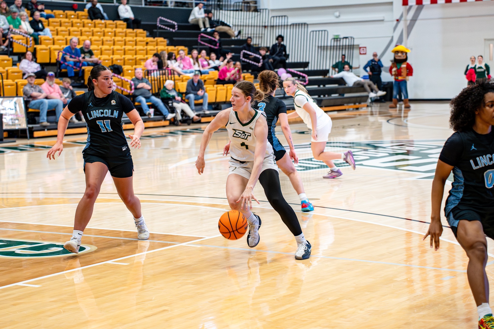 Missouri S&T women's basketball guard/forward Norah Gum driving the basketball into the lane with Lincoln University defenders around here in Gibson Arena.;