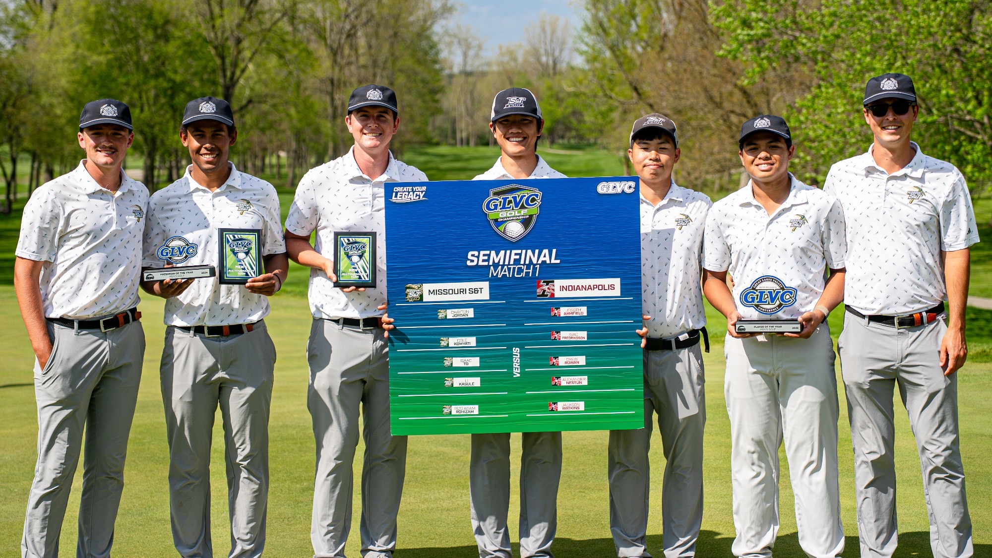 Left to right: Chayton Jordan, Li Kasule, Cole Komyati, Andy Su, Isaac To, Rizq Adam Rohizam, and head coach Connor Benjamin pose holding a “Semifinal Round 1” sign after advancing to the GLVC Championships semifinals following stroke play at Rock Hollow Golf Club.