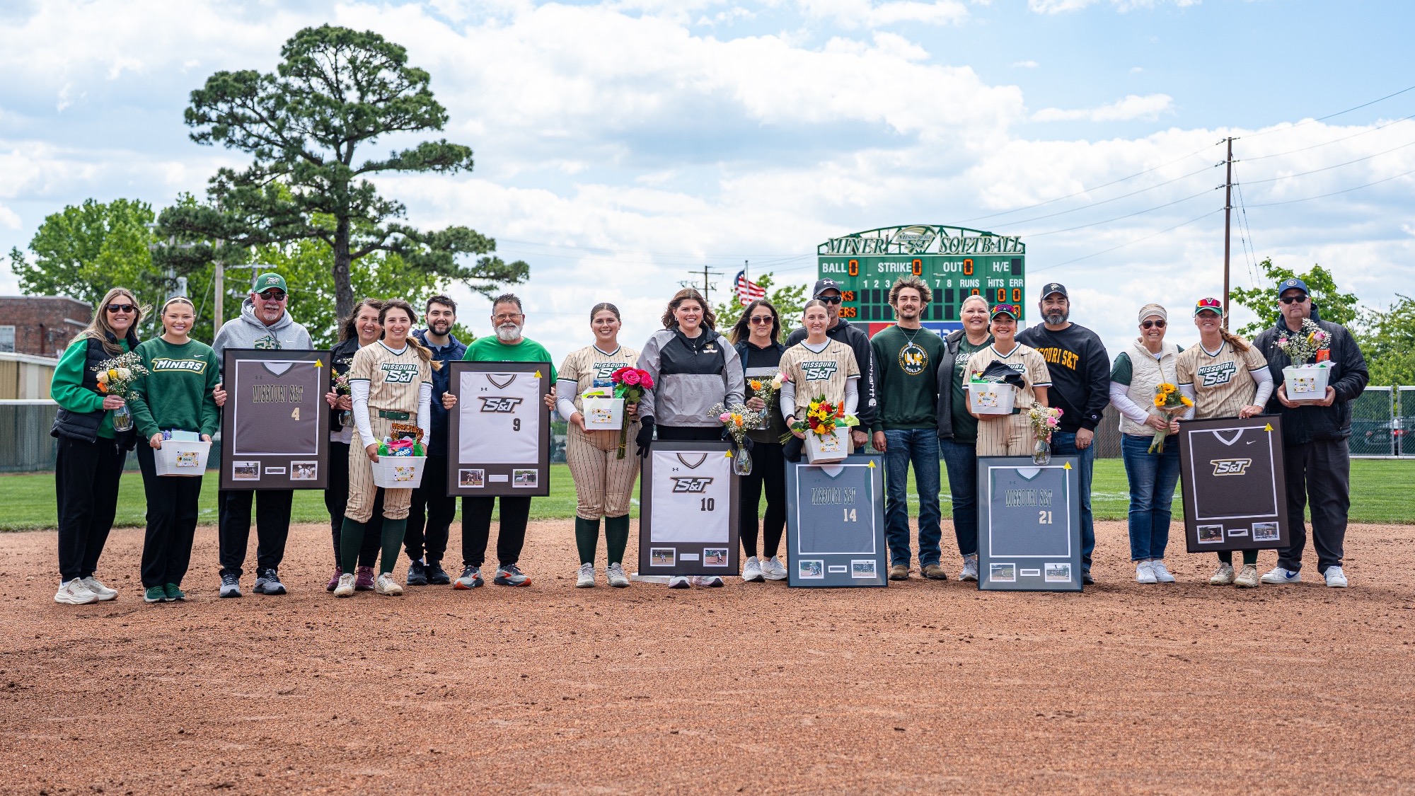 Missouri S&T group photo of the seniors celebrating Senior Day with their families on the Missouri S&T softball field.