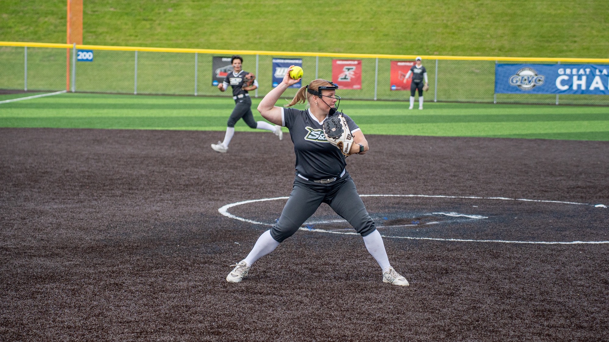 Missouri S&T pitcher Mia Miller grounding a ground ball and throwing it to the first baseman at the GLVC Tournament.