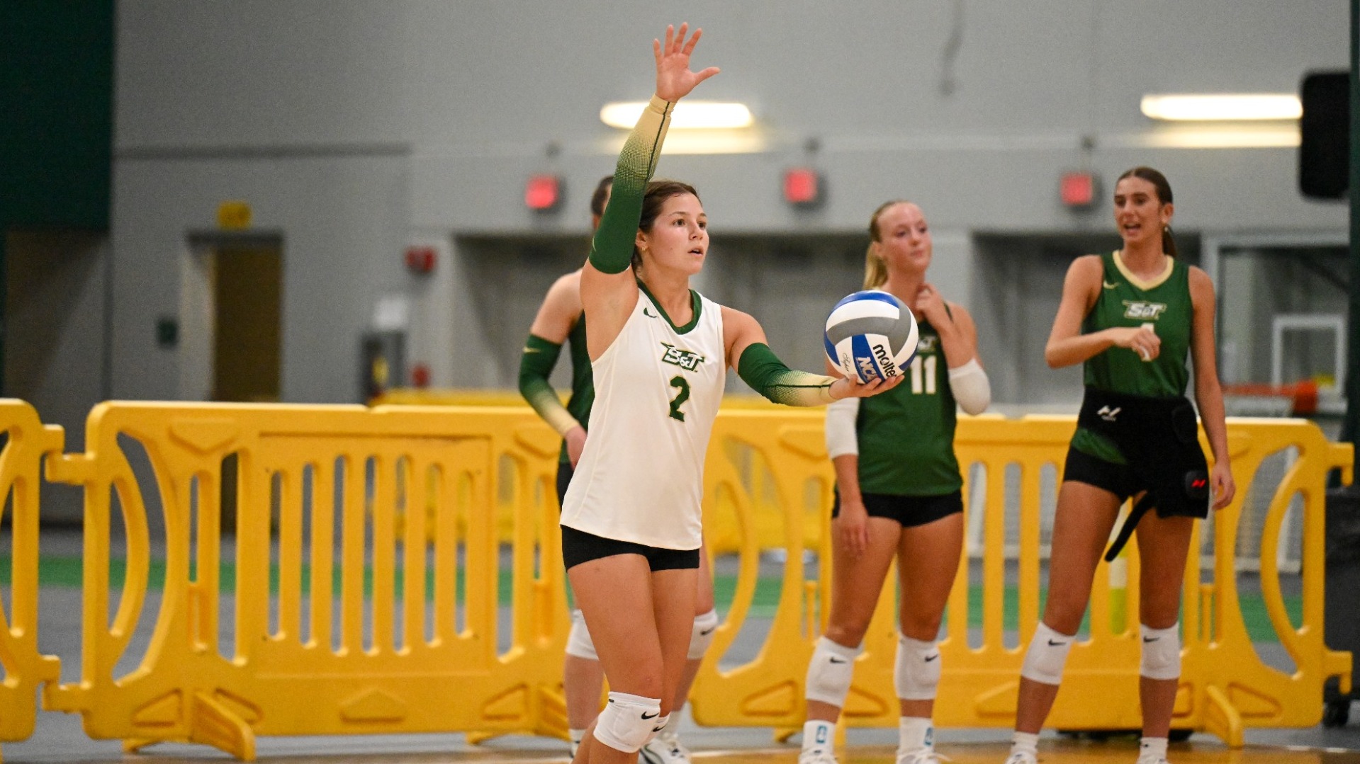 Adelyn Weiler of Missouri S&T Women's Volleyball photographed wearing a white jersey and about to serve while at MSSU Tournament
