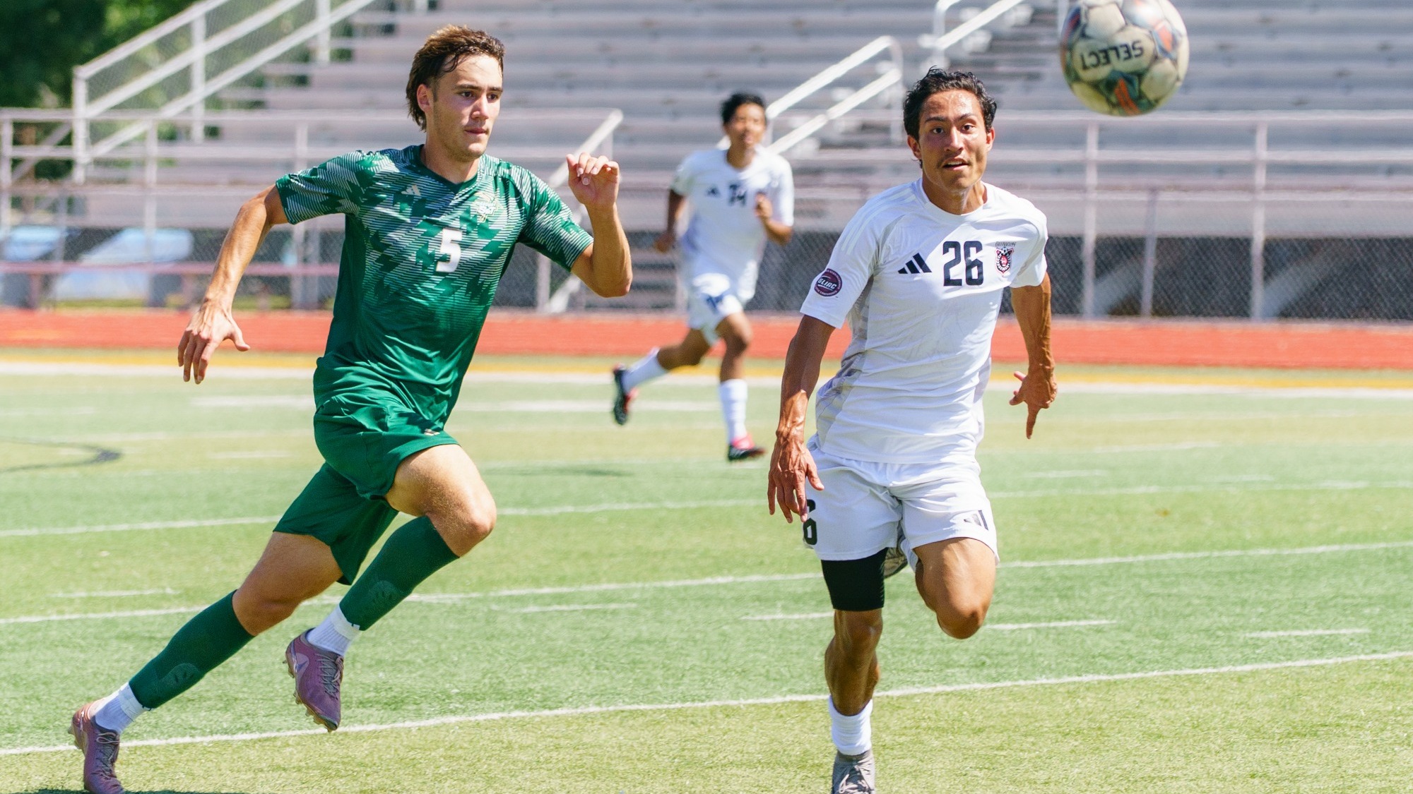 Griffin Heinen of Missouri S&T Men's Soccer photographed contending with a Davenport player to  win a ball 