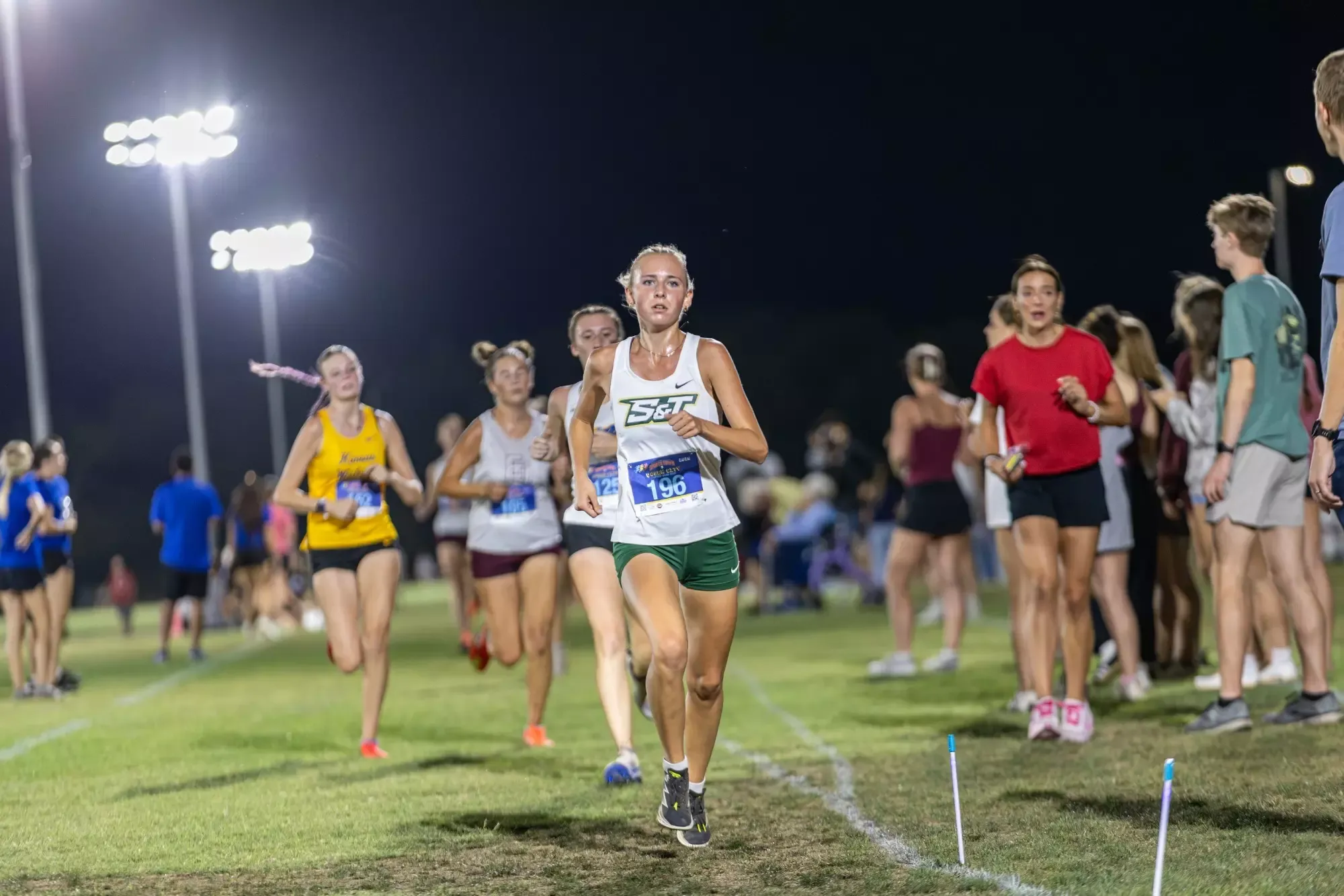 Molly Hays running on a grass cross country track
