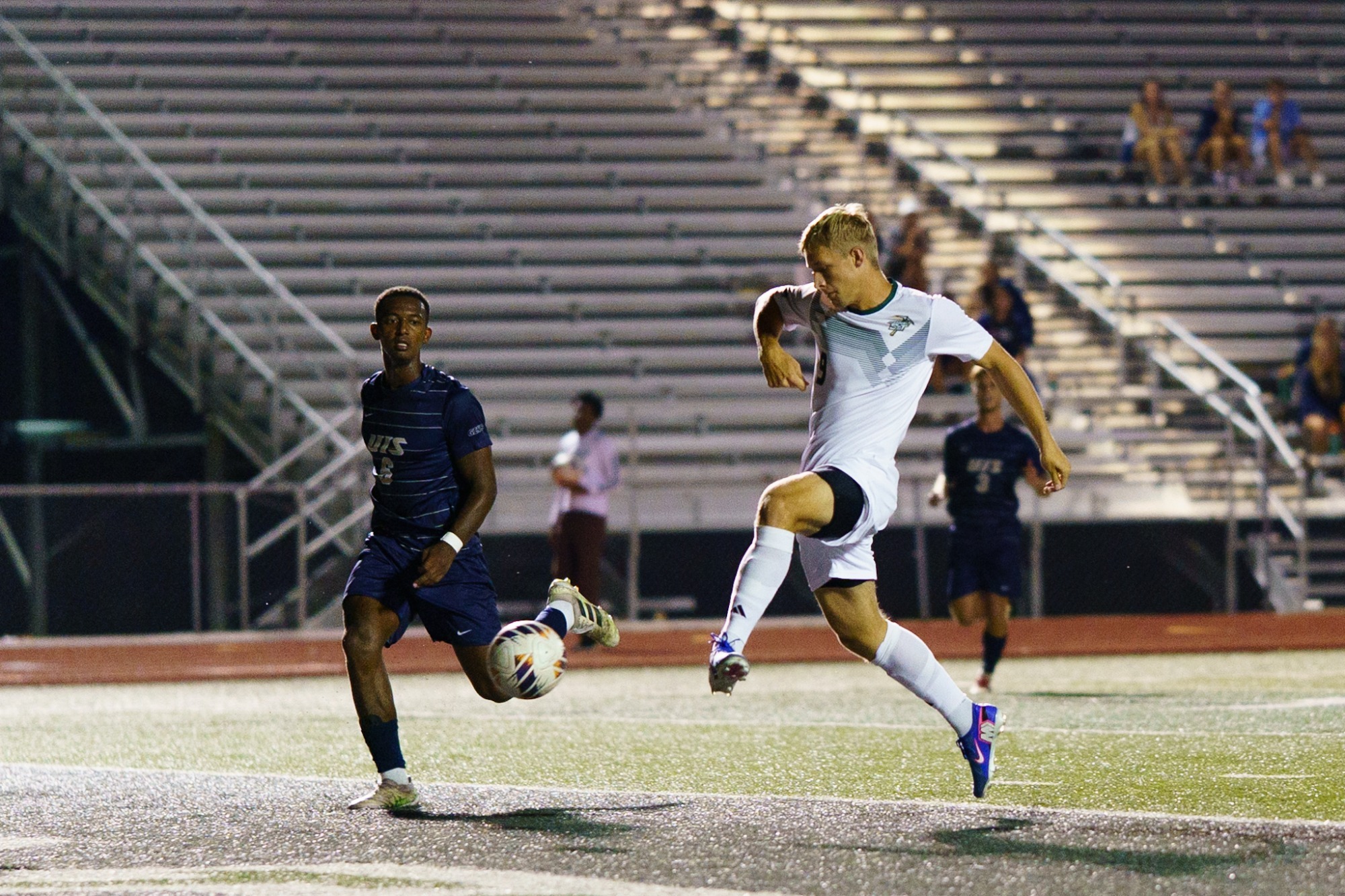 Mike Banasik for Missouri S&T in a white jersey and white shorts, jumping to make a goal 