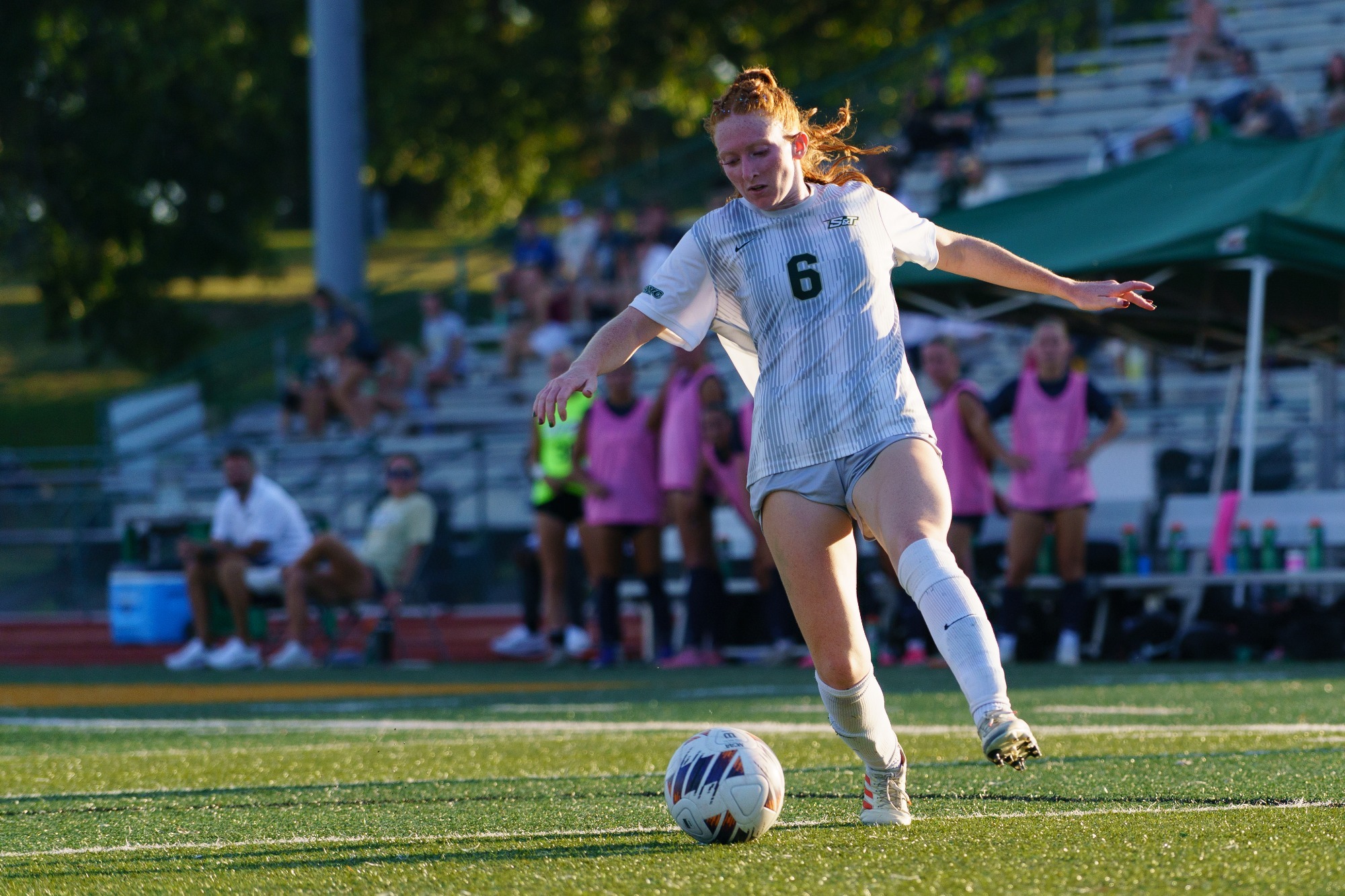 Aubrey Case for Missouri S&T in a white jersey and white shorts guiding the ball with her left foot