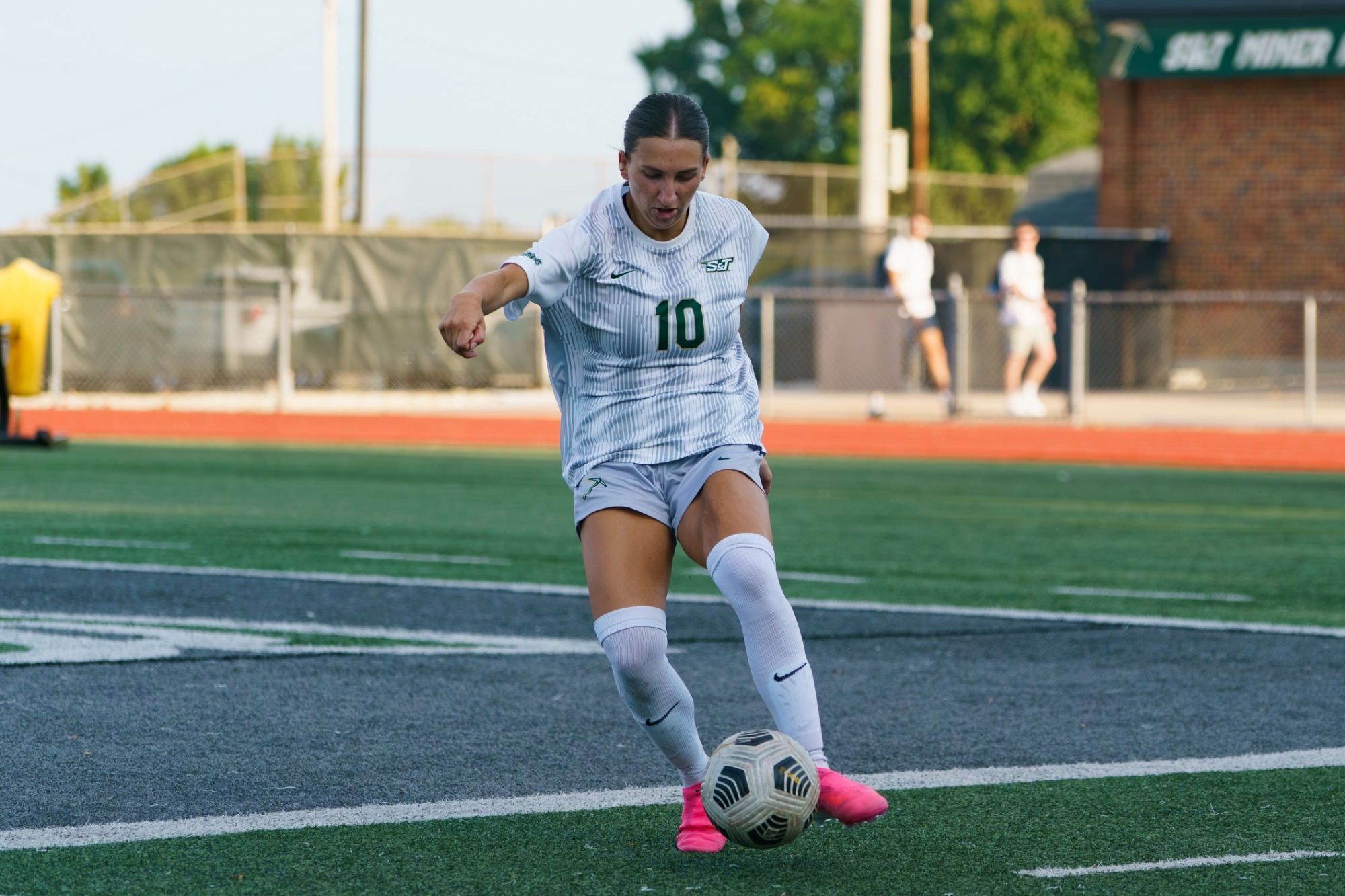 Drue Gaal in a white jersey and white shorts attacking the soccer ball 