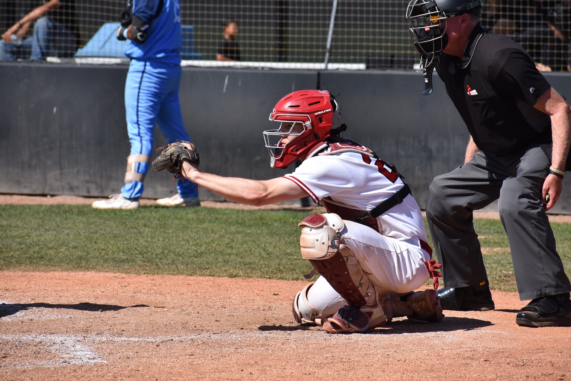 Caden Denning receives a pitch as catcher