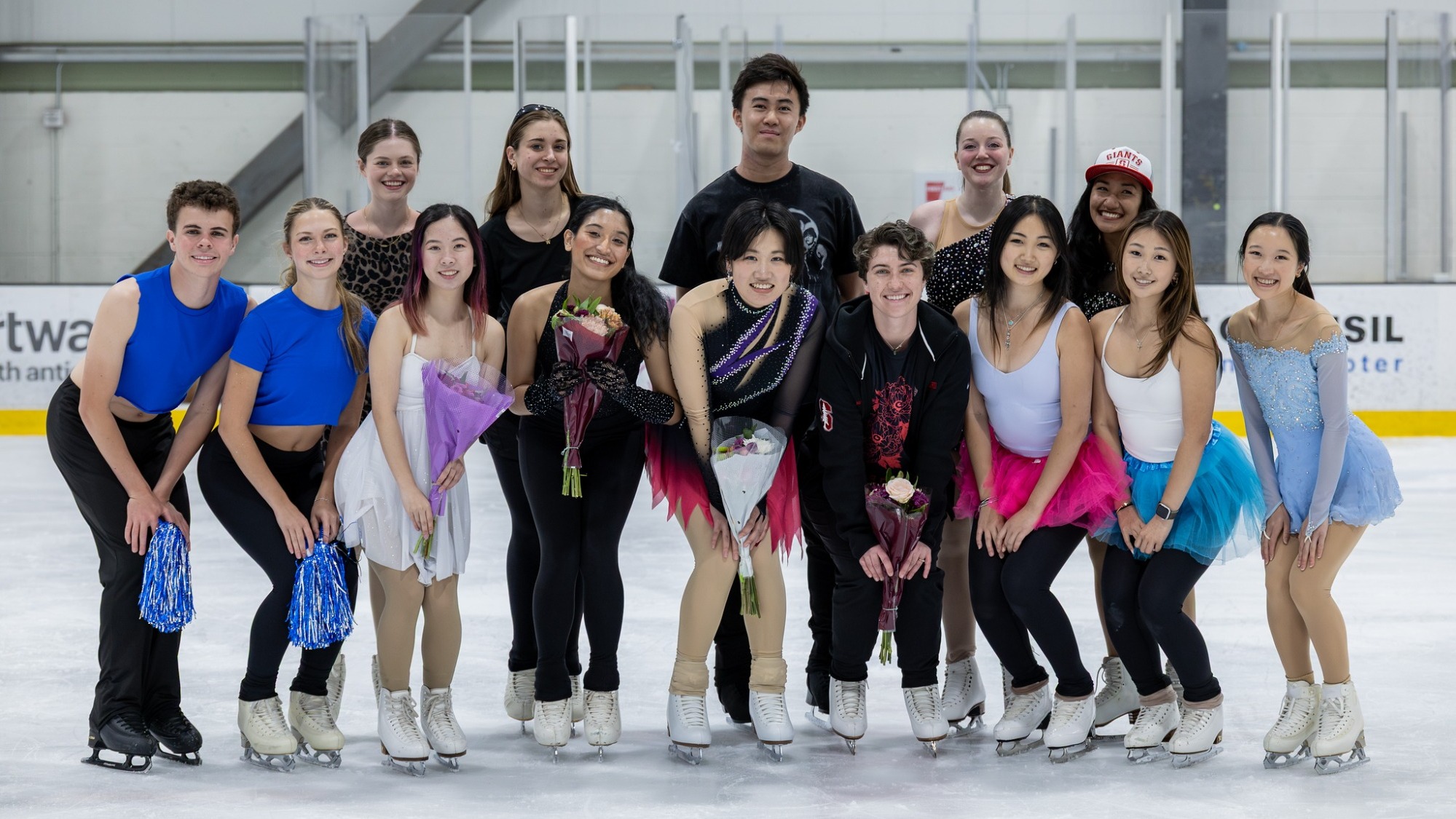 Stanford Skating Team stands on ice smiling