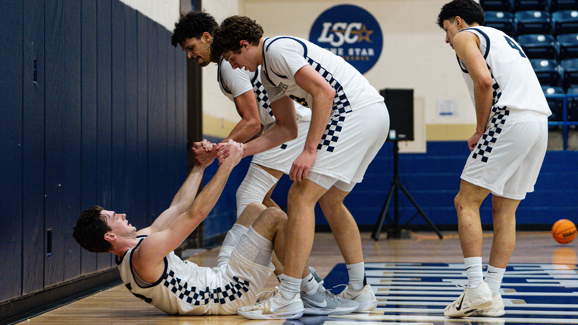 Teammates Help Conor McManus up