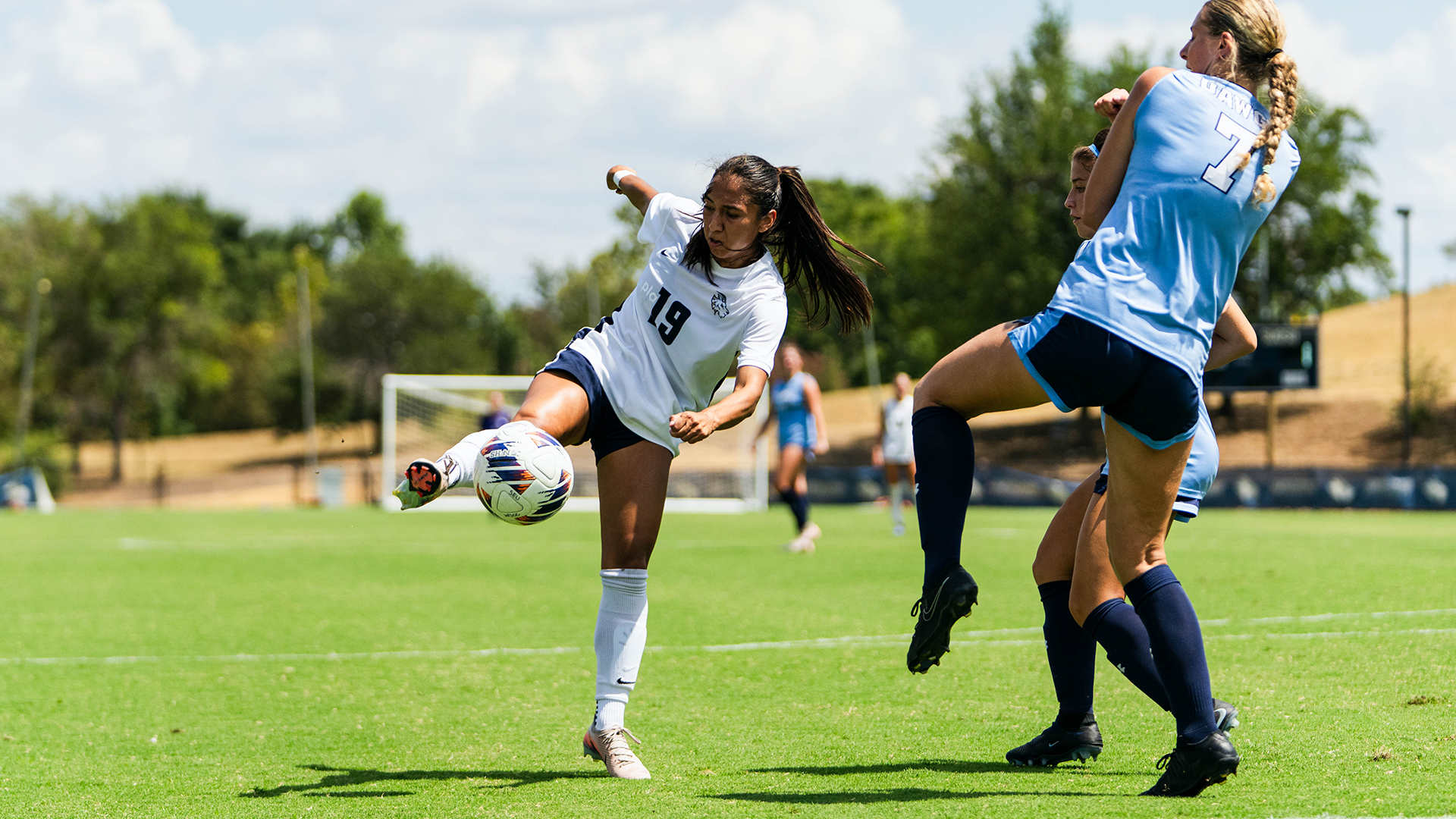 Jisell Zavaleta Denova takes a shot against two defenders