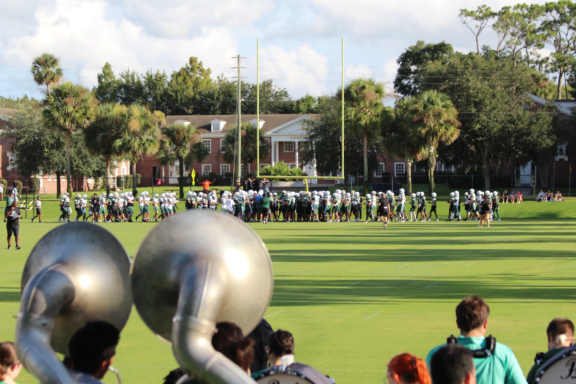 The team breaks it down on the field during the scrimmage while the Hatter band plays.