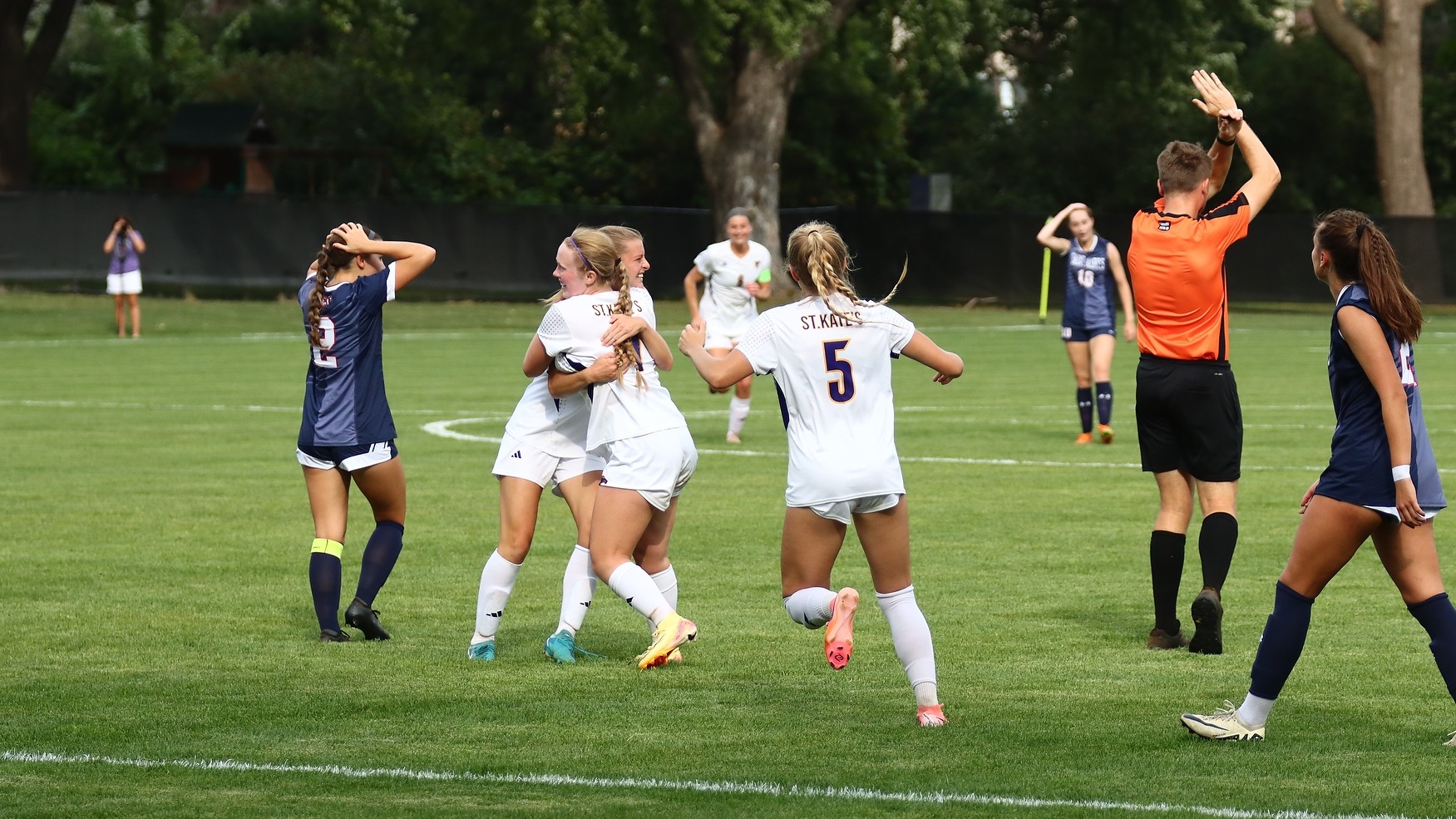 St. Kate's soccer players celebrating goal 