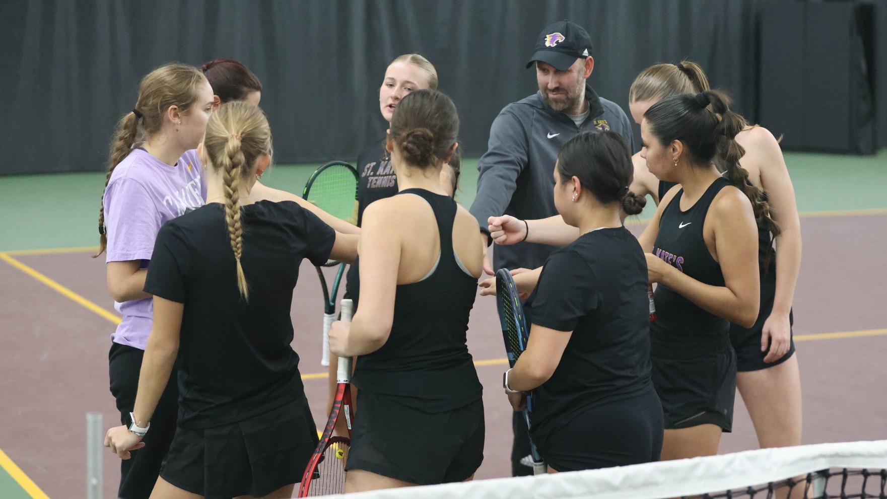 tennis team huddle at base line