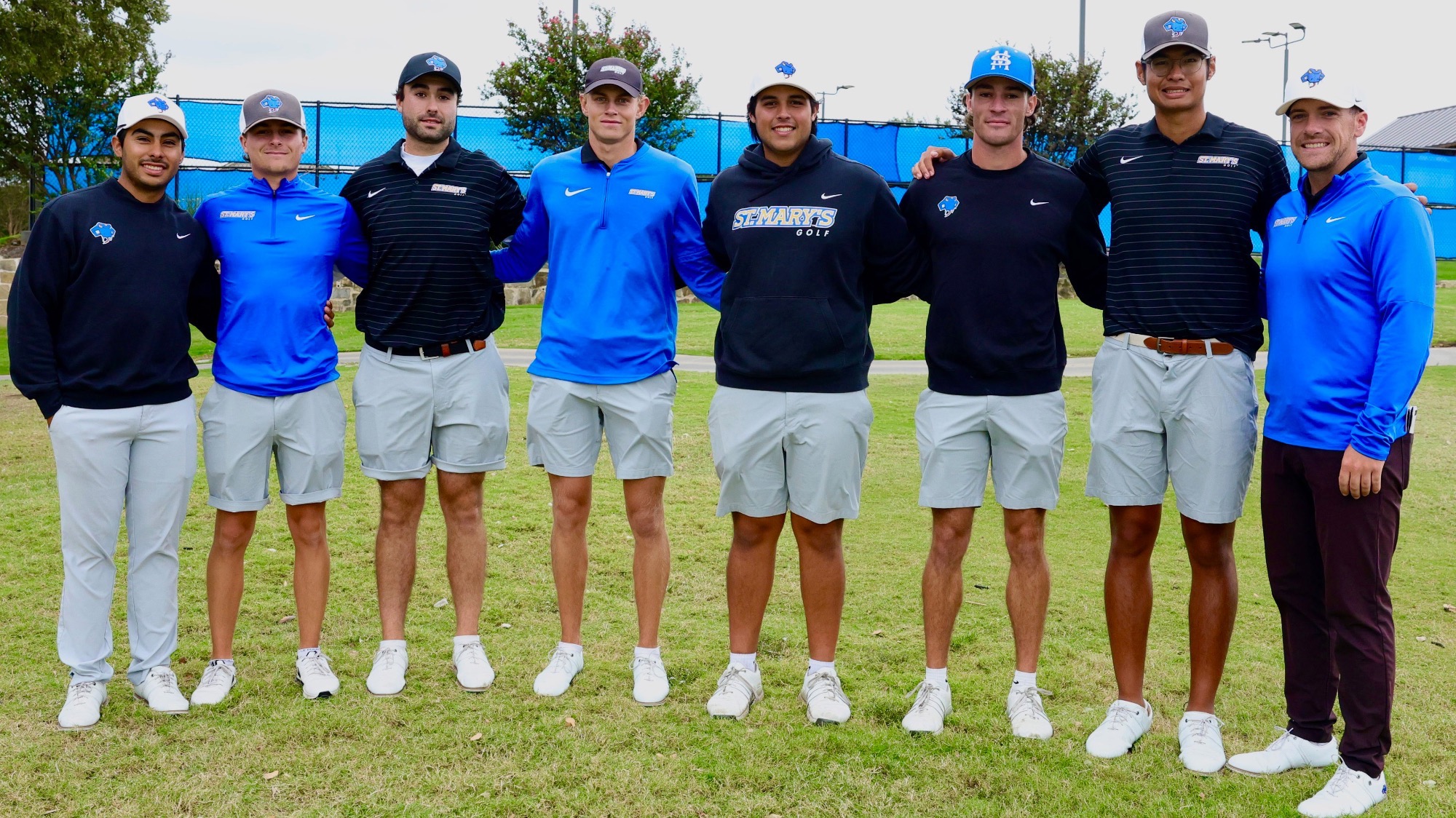 The Men's Golf team poses arm in arm after winning the DBU Classic in Rockwall.