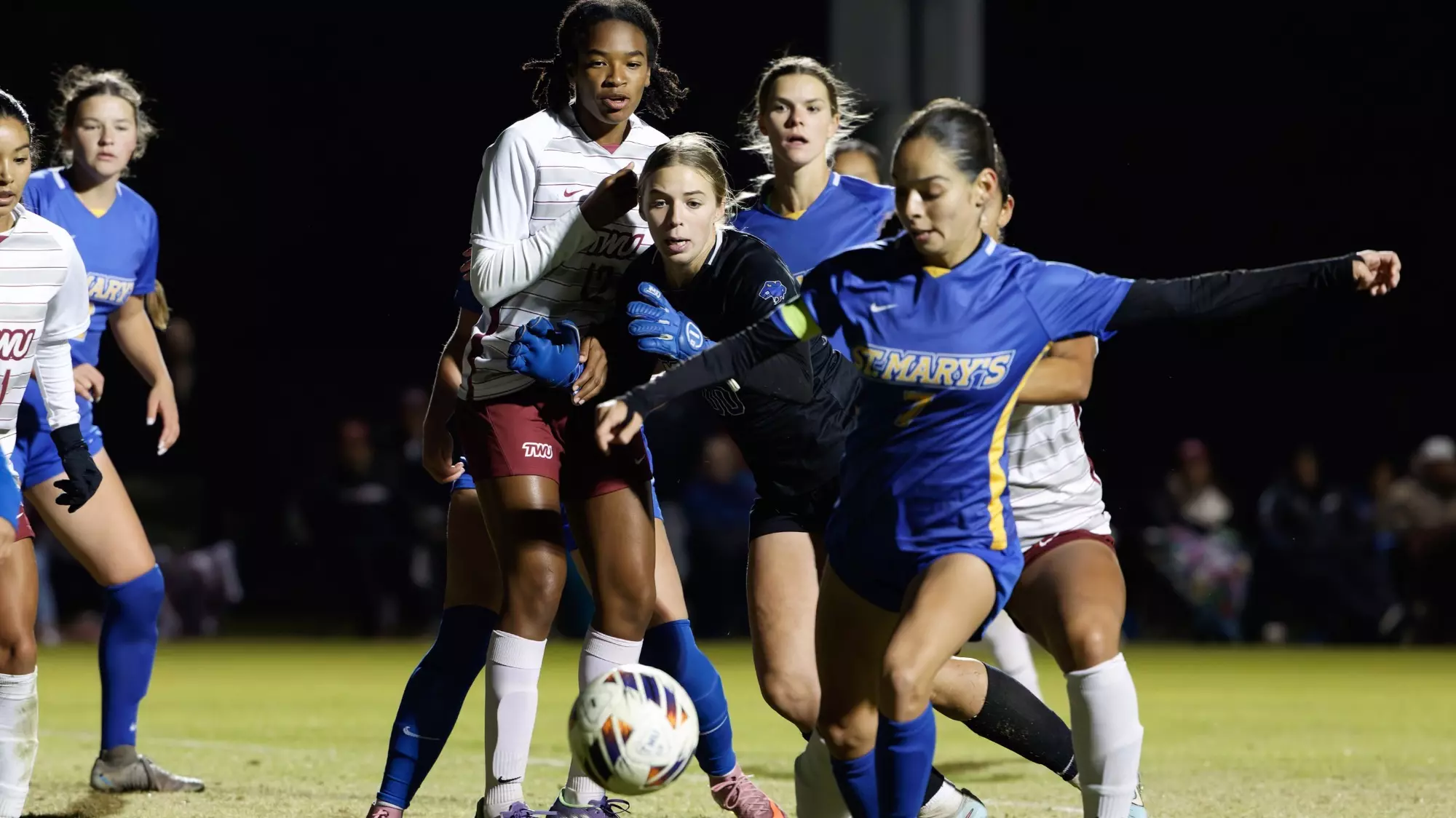 Shelby Paniagua clears the ball out of the box as keeper Haley Faucette and Elena Kossler look on.