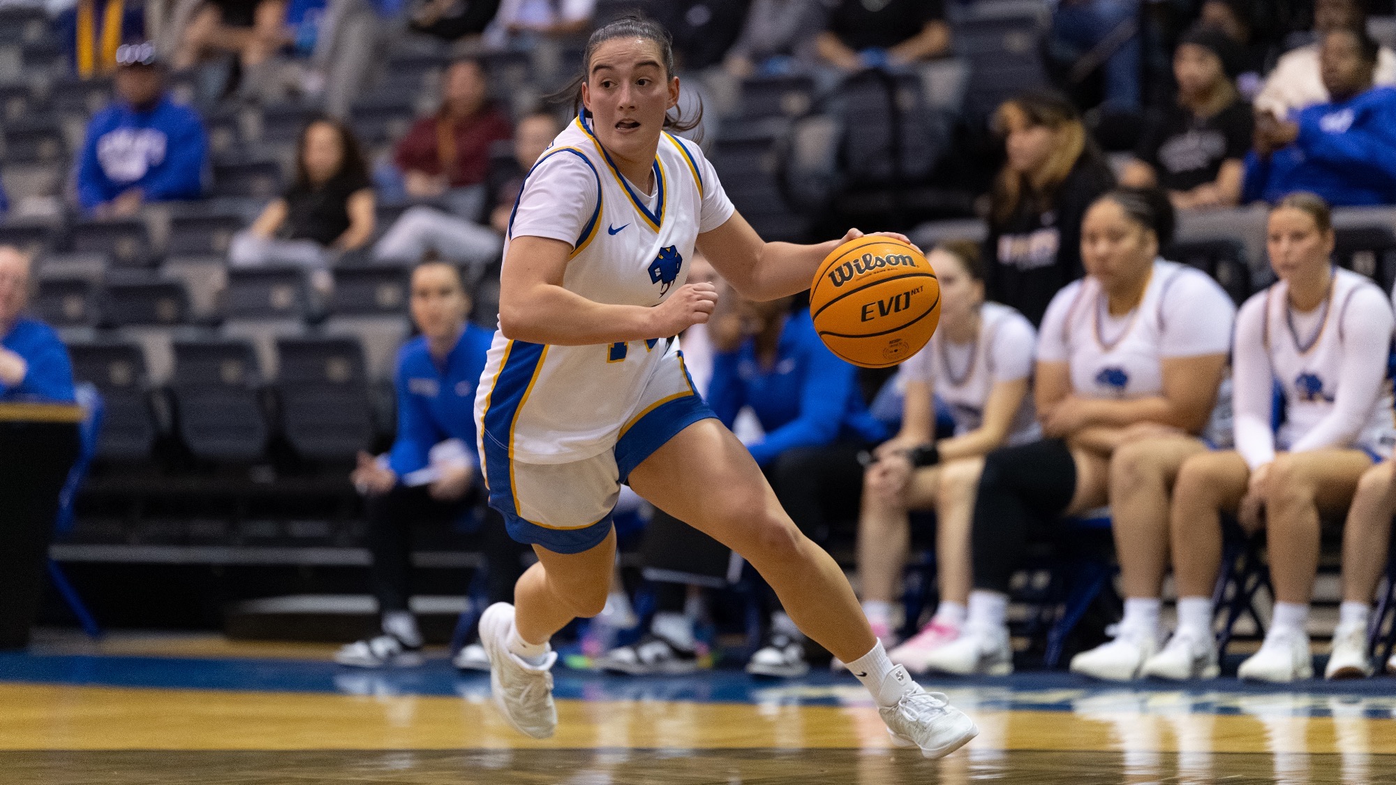 Aina Mayou dribbles with her left hand as she drives to the basket in the second half against Washburn.