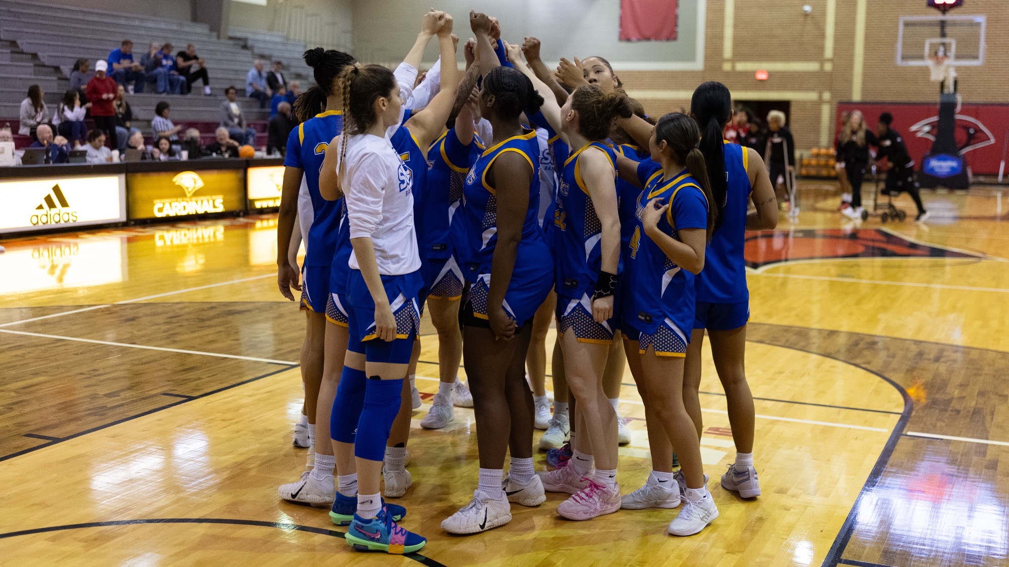 The women's basketball team huddles before the game at UIW.