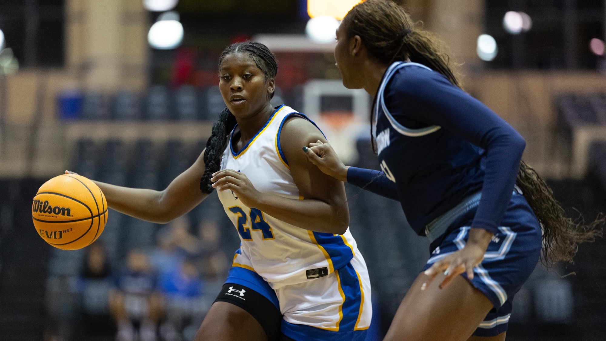 Christin Callens dribbles the ball against a defender.
