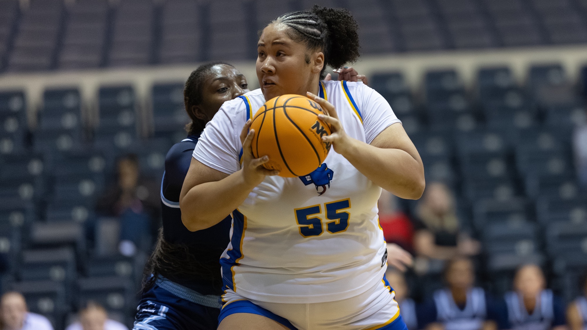 Sian Phipps drives to the basket with the ball in both hands at chest level.