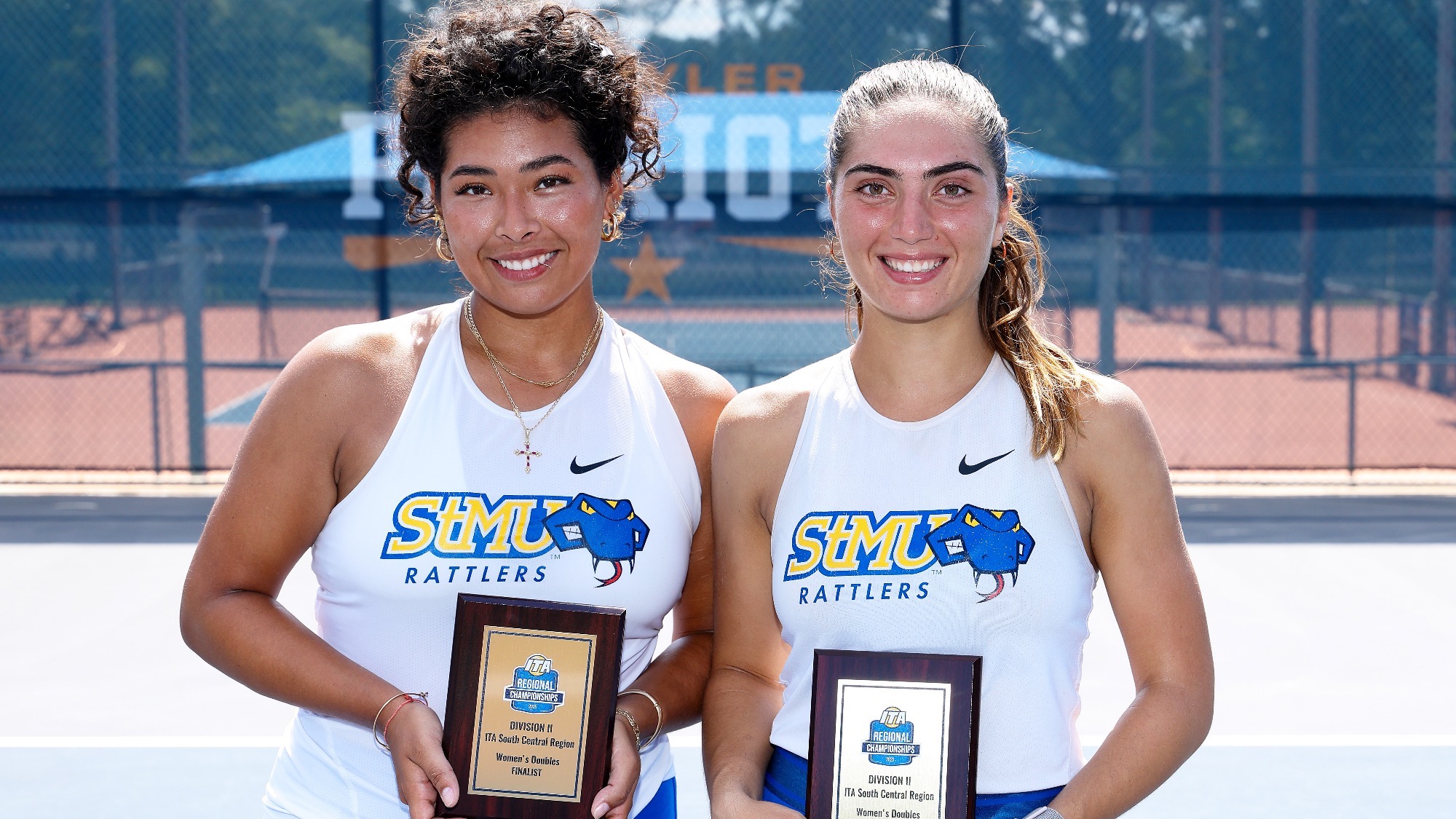 Gia Posito and Alessia Terlizzi pose with their ITA Regional Finalists trophies on the courts at UT Tyler.