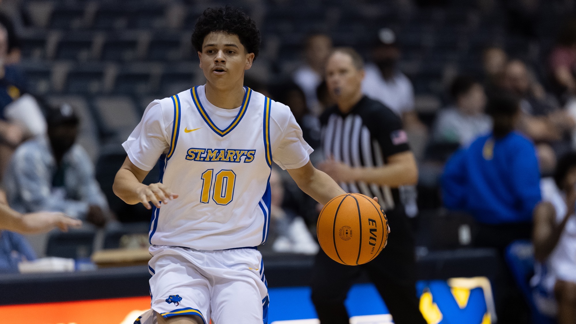 Freshman Raken Vargas dribbles the basketball down the court.