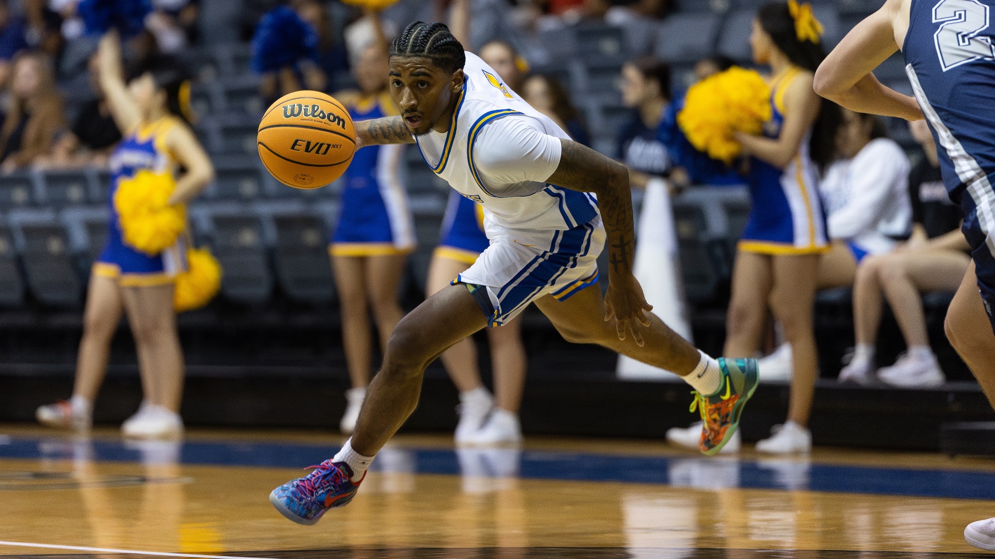Damani Claxton gets low to the ground to dribble-drive to the basket.