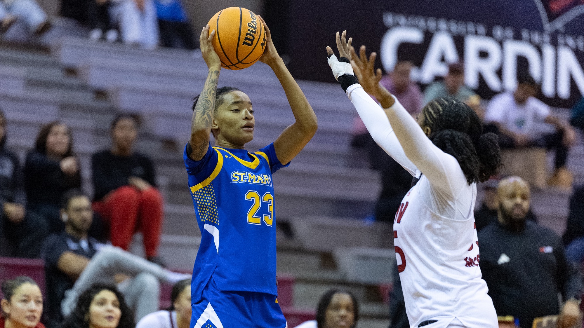 Lena Newby holds the basketball over her head as she studies the court.