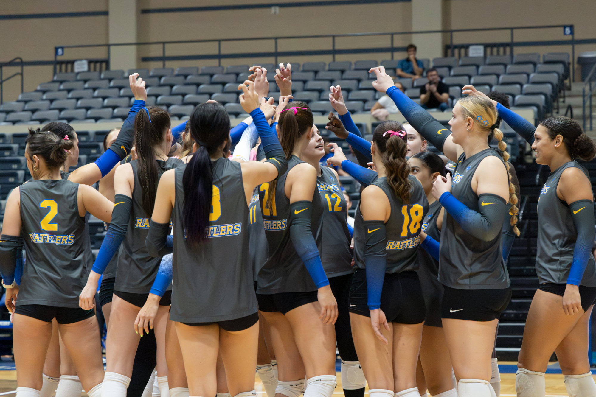 The entire team huddles with Fangs Out symbols in the air.