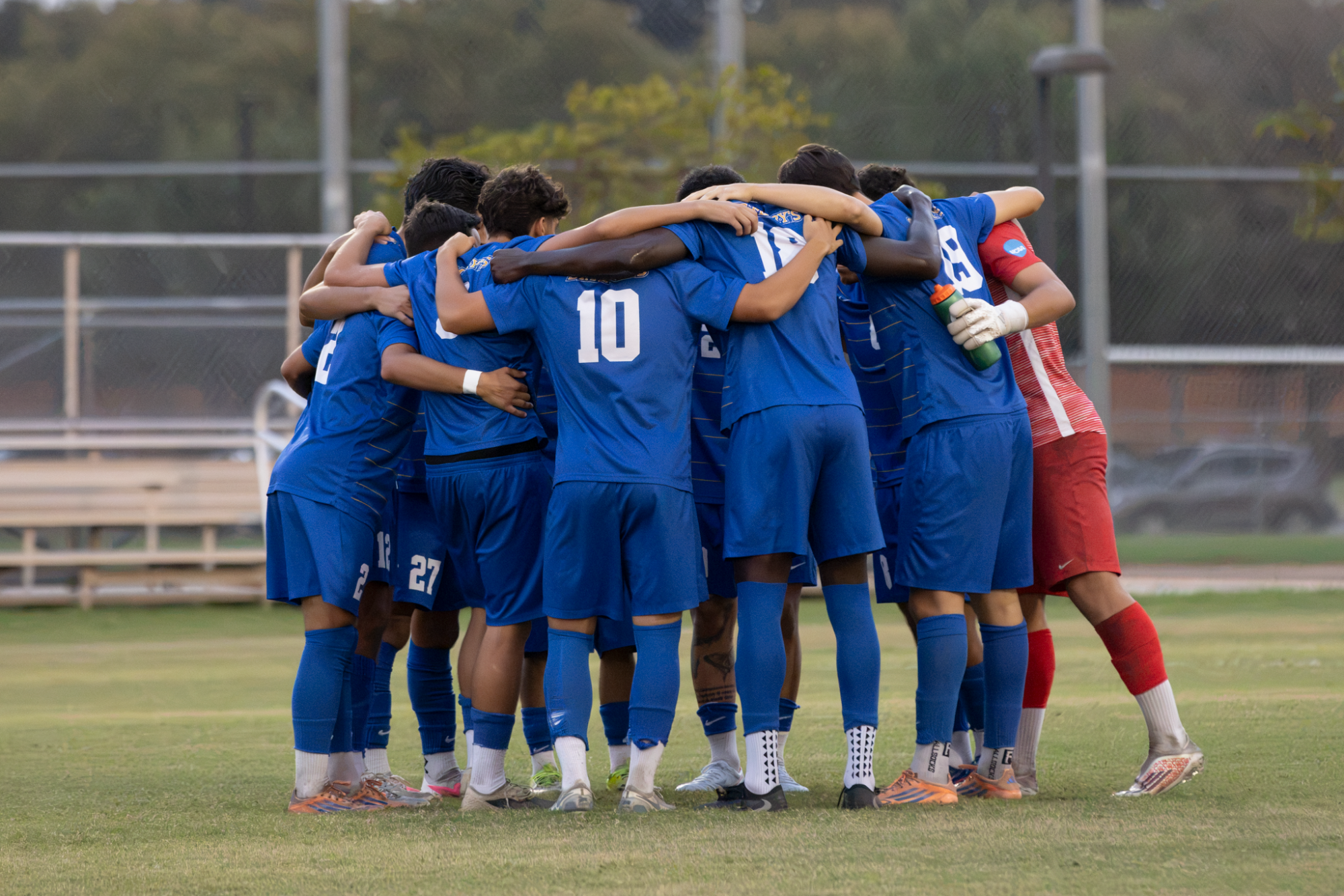 The team huddles before kicking off.