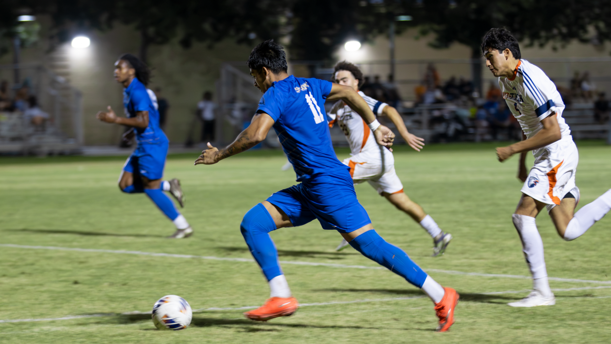 Sebastian Poblete drives up the pitch with the ball on his right foot.