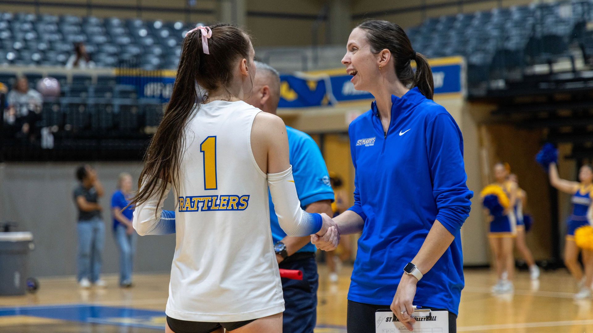 Coach Pelky holds Haleigh Wilk's hand as she comes to the sideline for a chat.