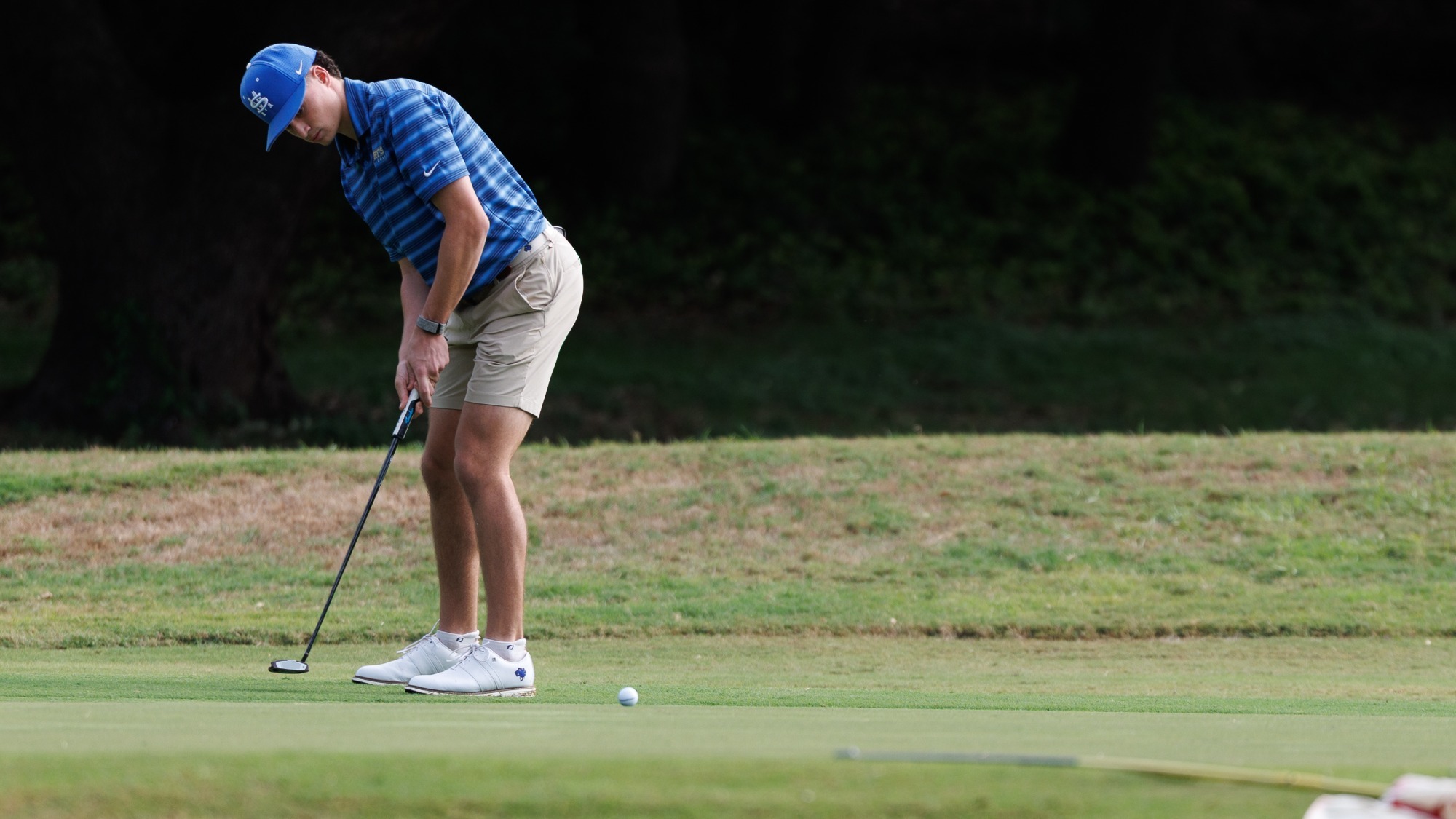 Matthew Lewis putts from left to right on the screen.