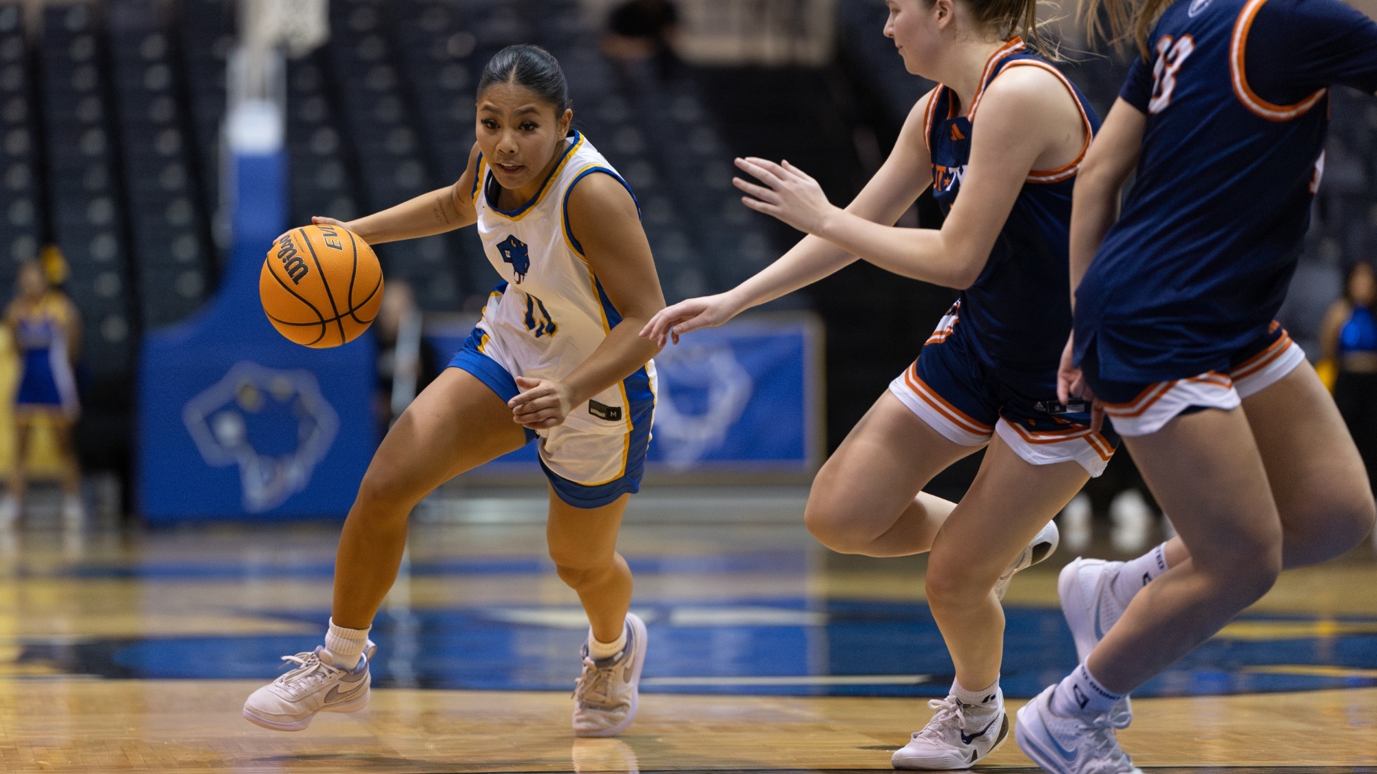 Allie Garcia drives to the basket with a defender on her left hip.
