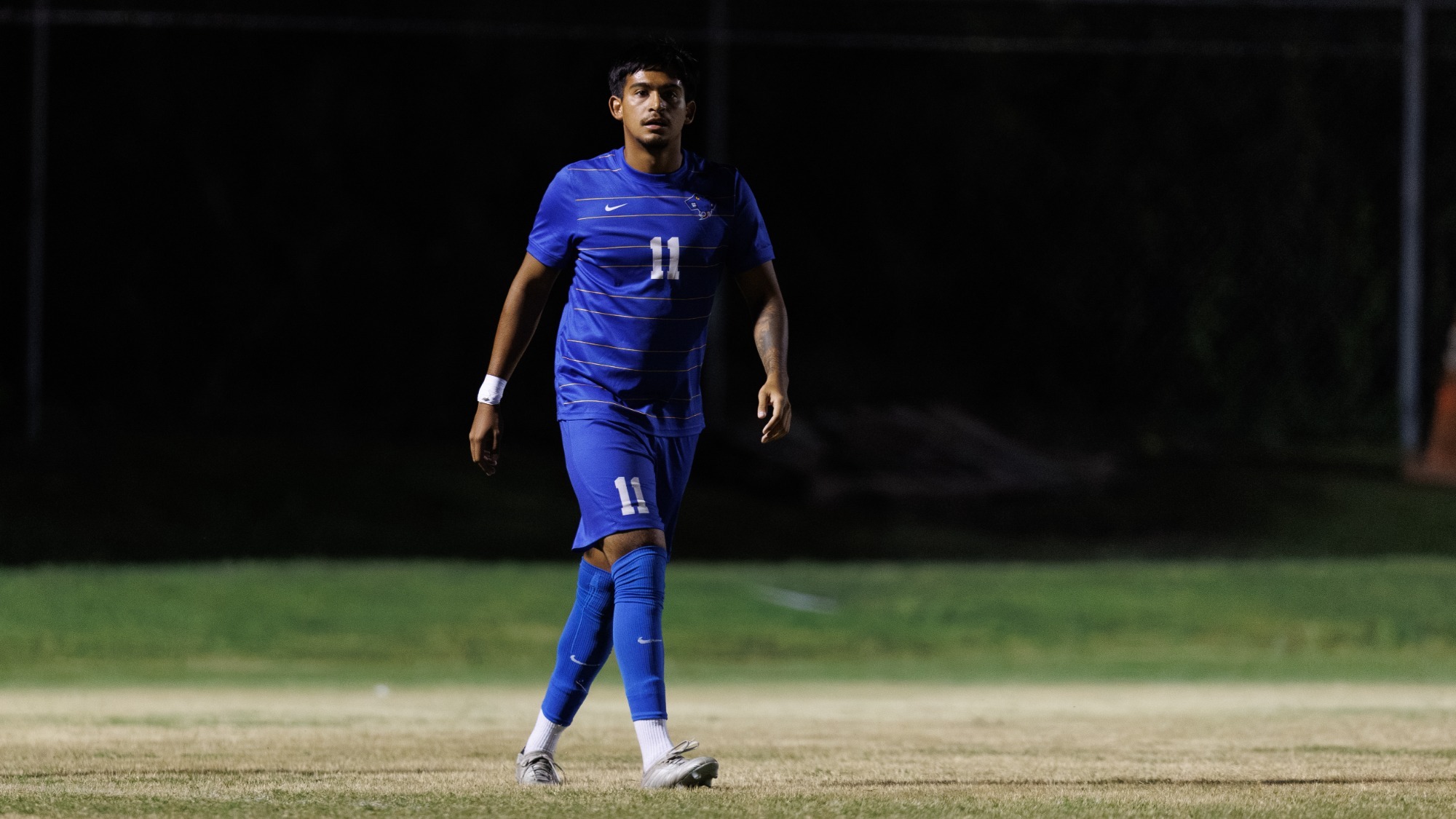 Sebastian Poblete stands in the middle of the pitch.