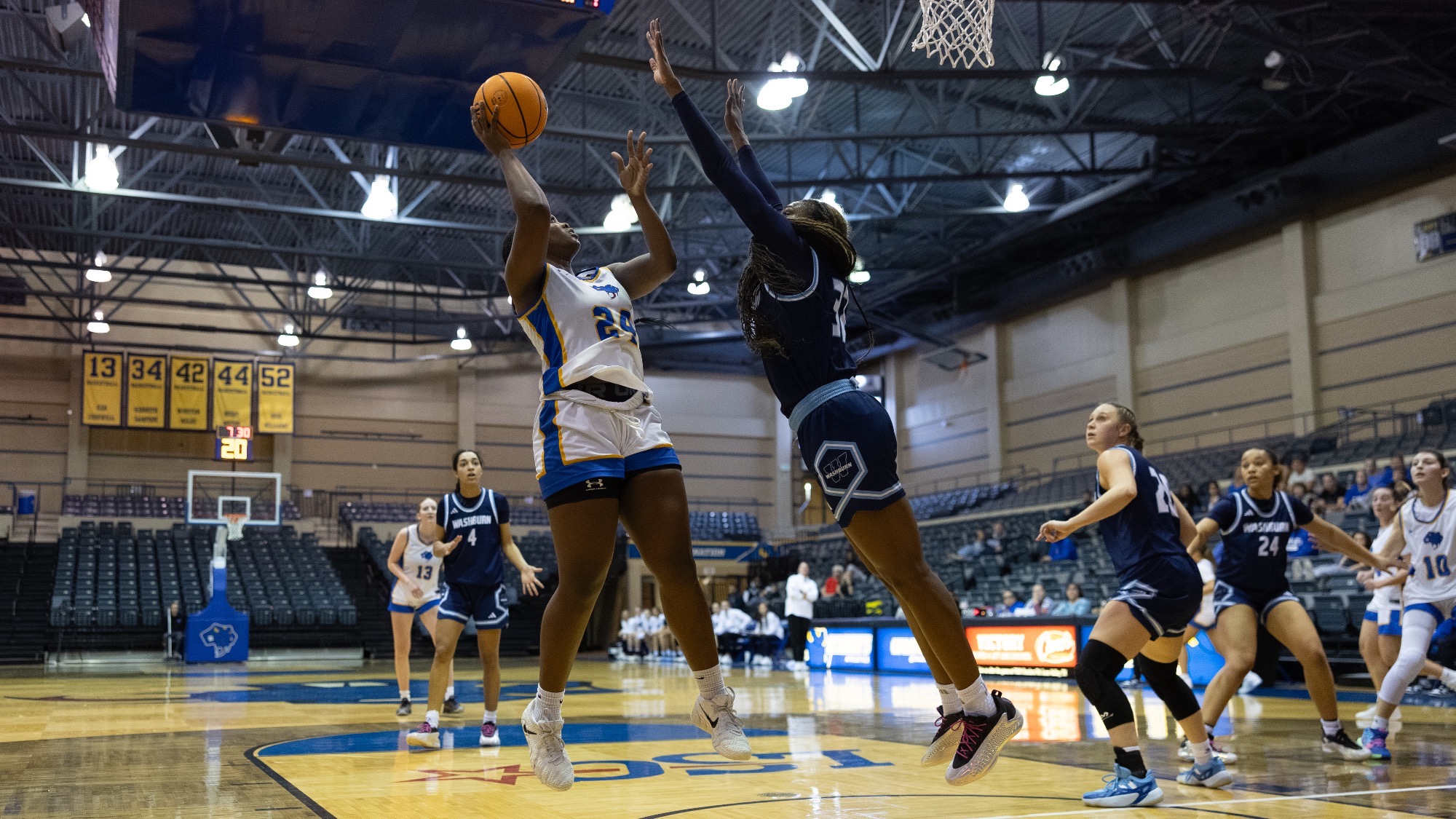 Christin Callens shoots over the outstretched arms of a defender.