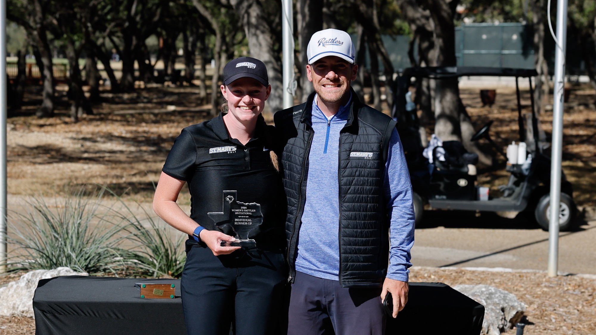Taylor Wilczek stands with Coach McCarthy and her Runner-Up Trophy from the Rattler Invitational.
