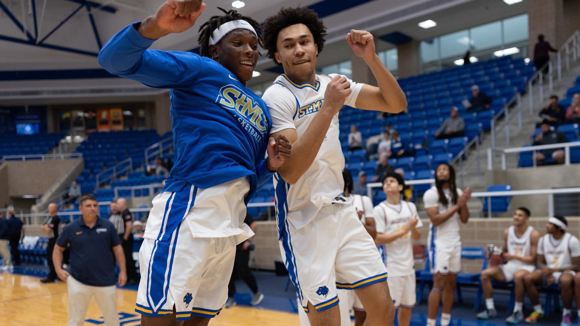 Wayne Wiggins and Eddie McPhee jump and bump shoulders during the starting lineups.