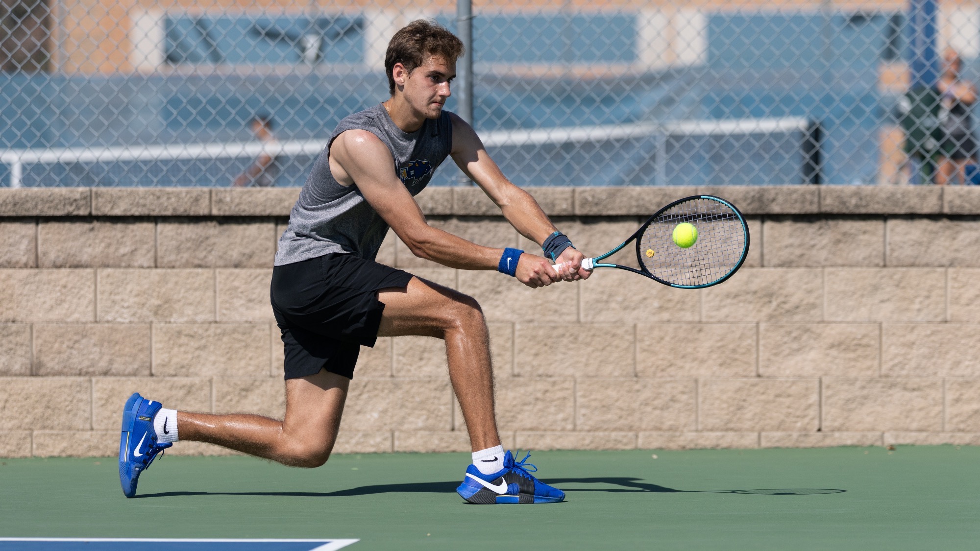 Nikita Gavrilonoks goes low to hit a two-handed backhand.