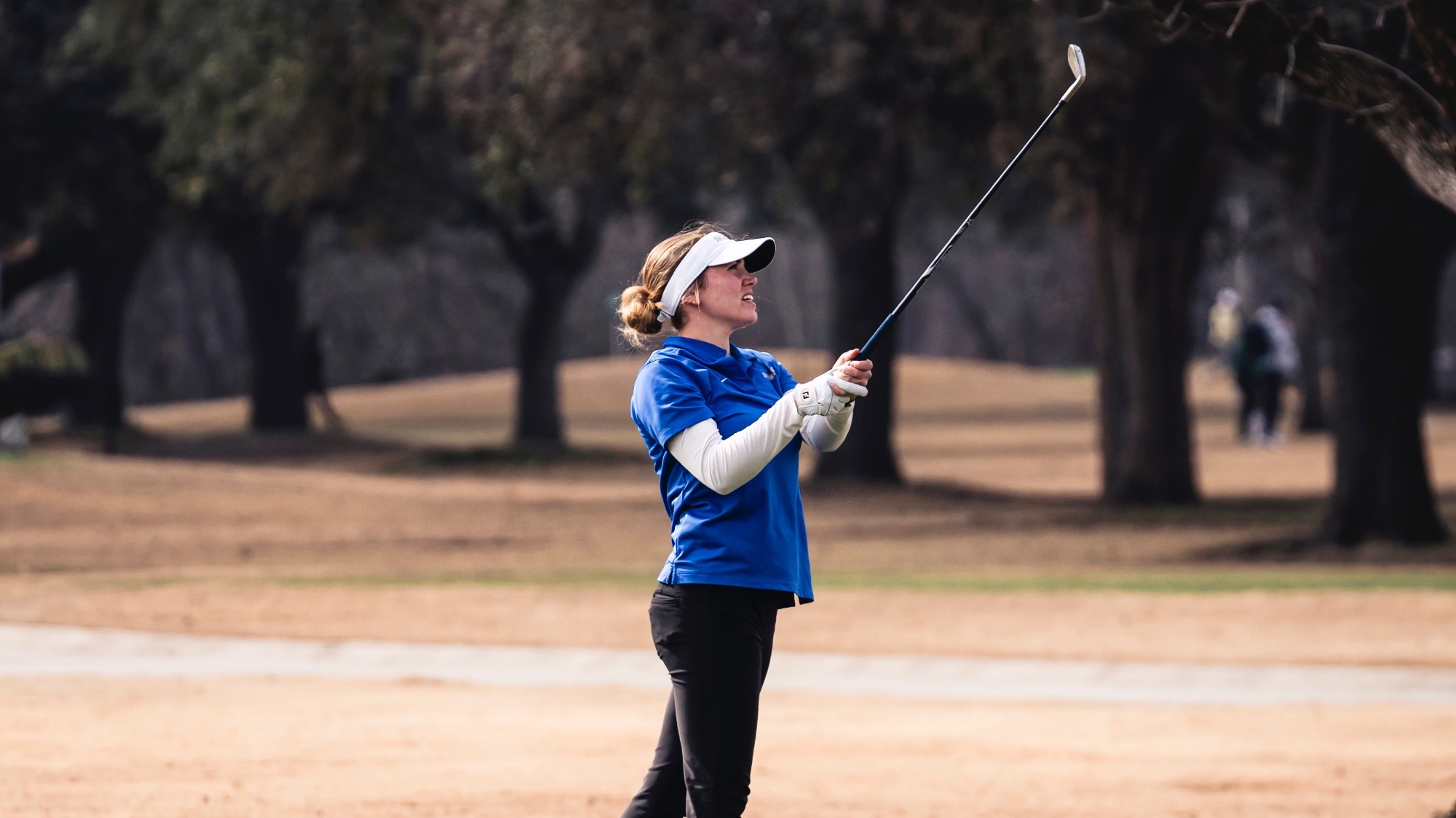 Sophia Perkins watches the flight of her ball after teeing off.