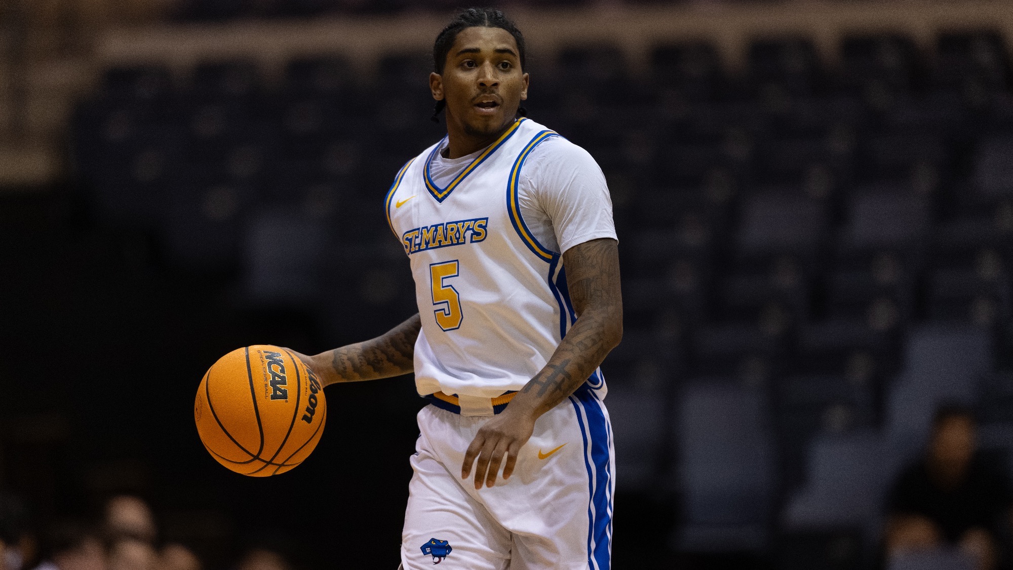 Damani Claxton brings the ball down the court.