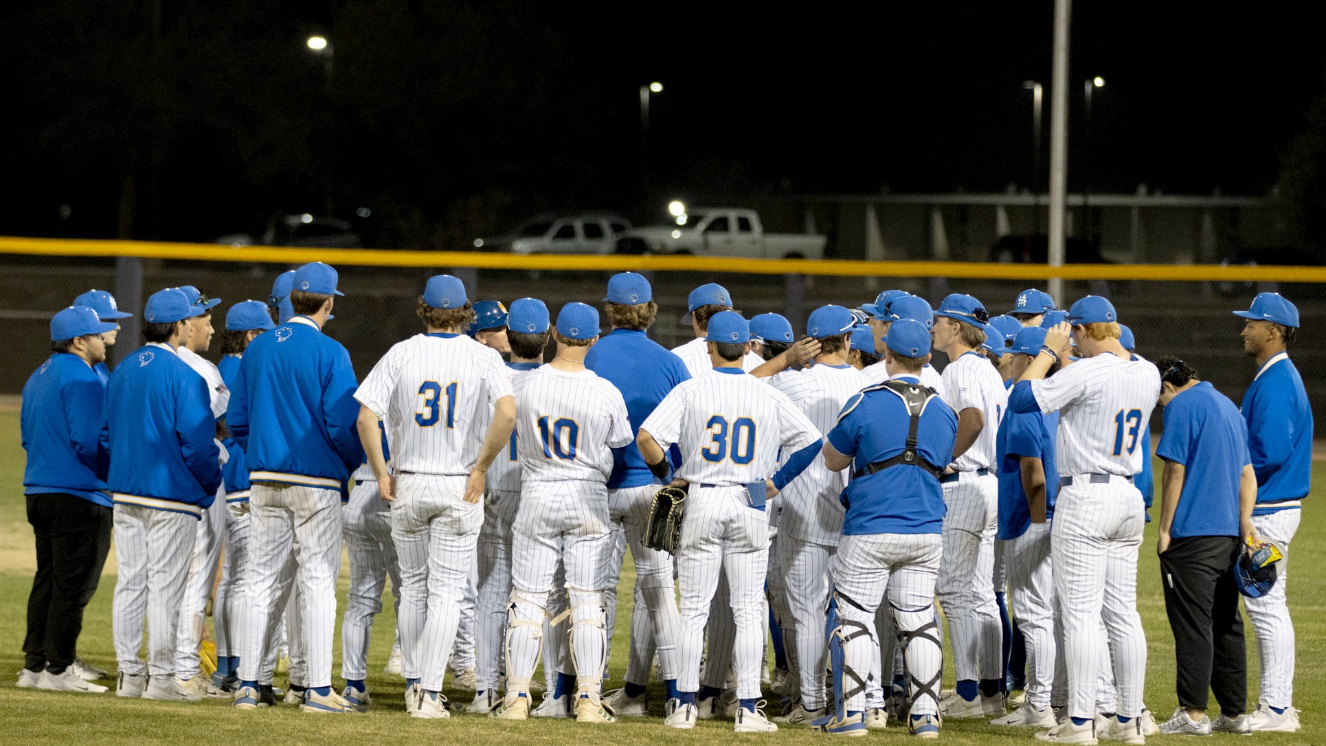 The Rattlers' baseball team huddles after the conclusion of game one against Oklahoma Christian.