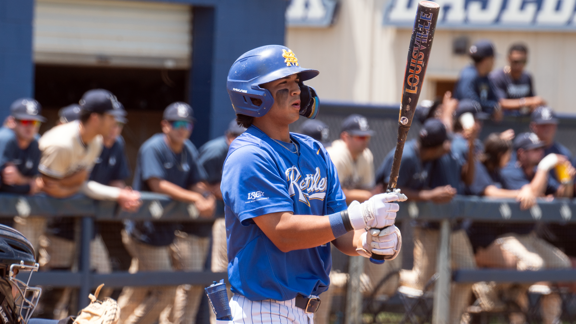 Jacob King exhales as he looks at his bat before stepping into the batter's box at St. Edward's.