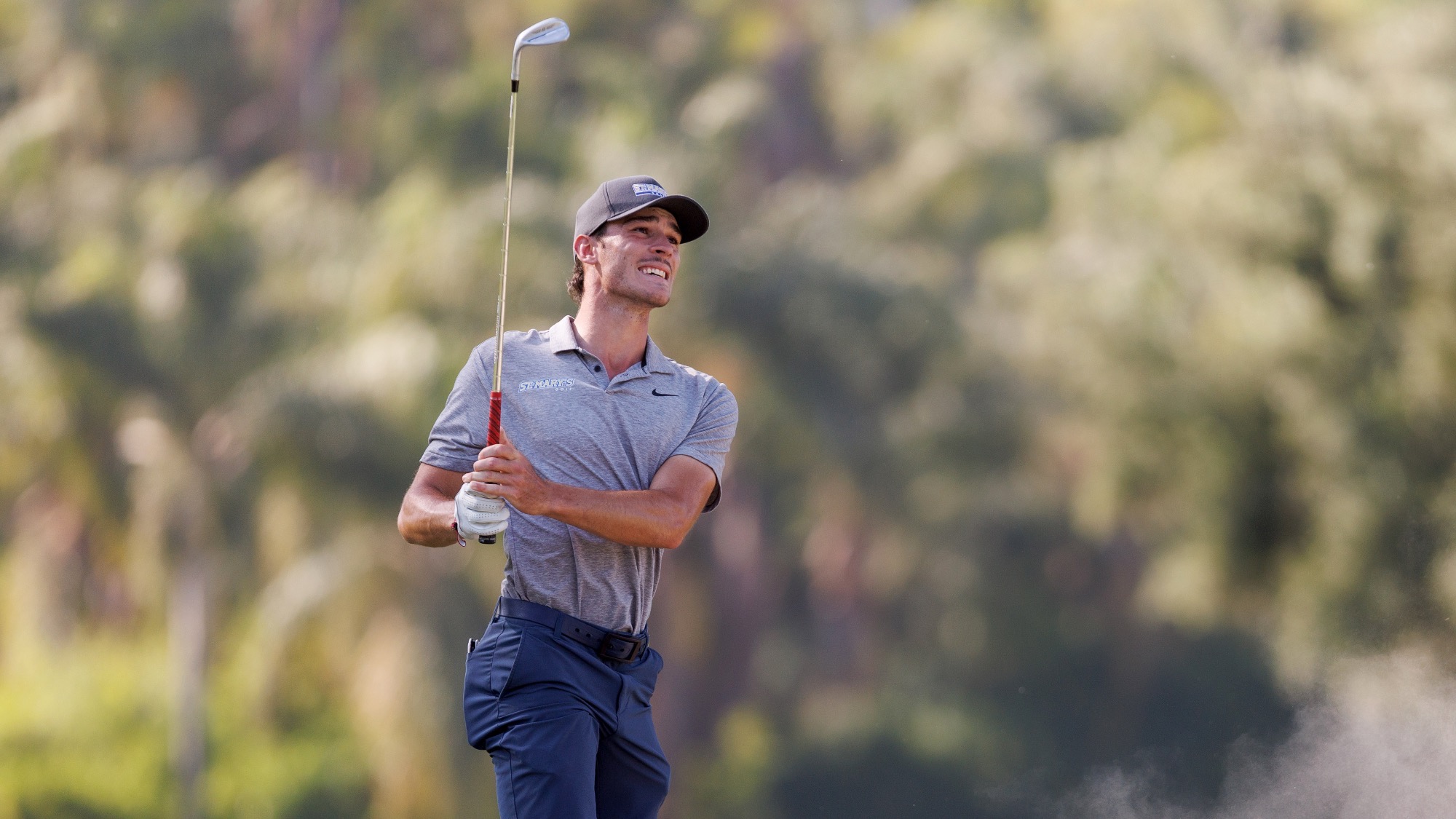 Baptiste Touchard follows the flight of his golf ball after hitting a shot out of the sand.