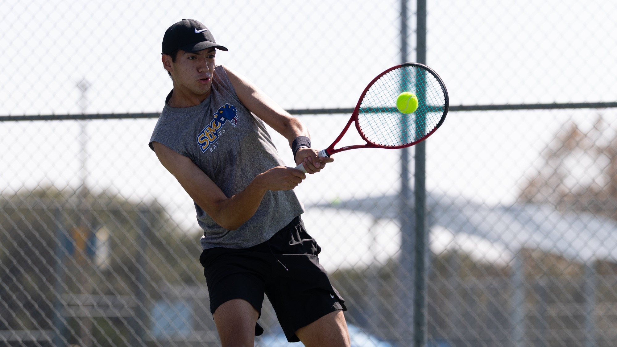 Diego Alvarez hits a two-handed backhand.