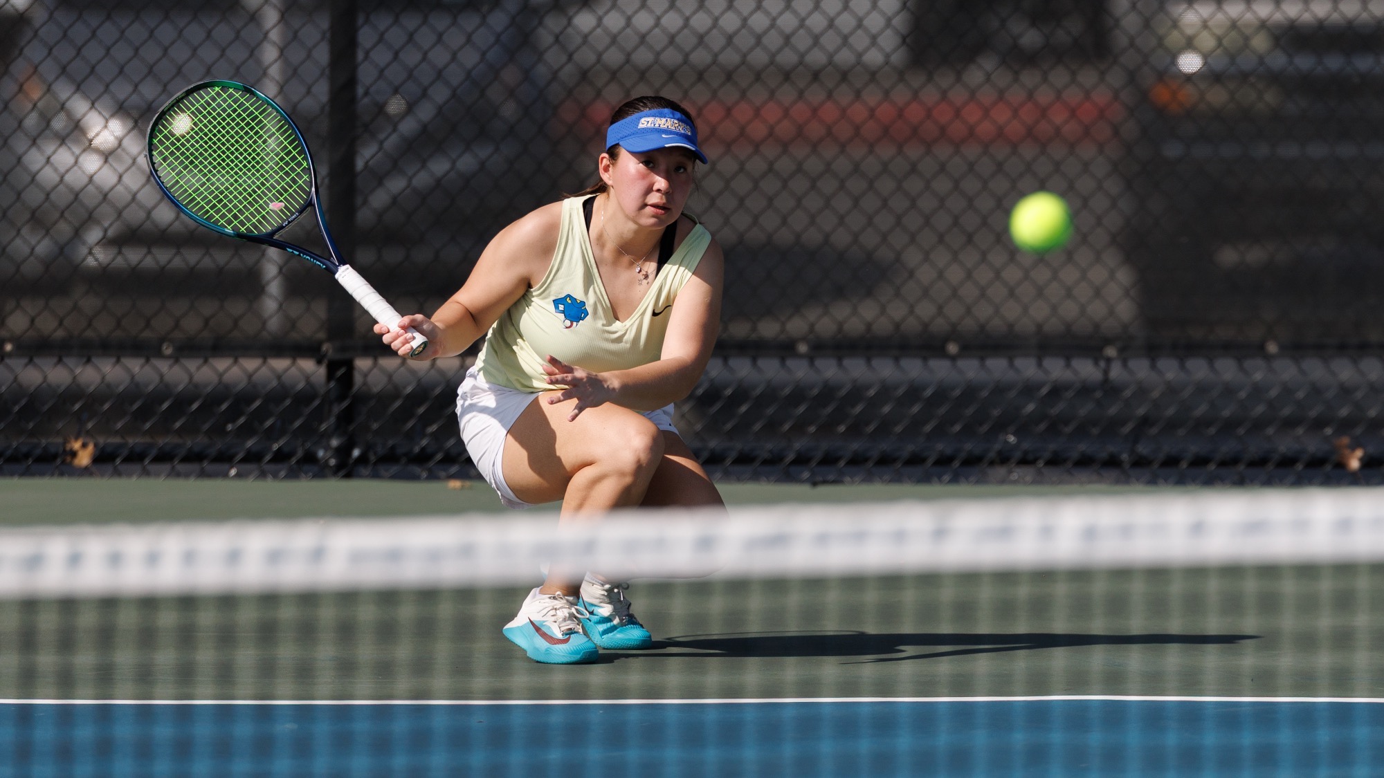 Janel Ospanova crouches down to return a low shot at UTSA.