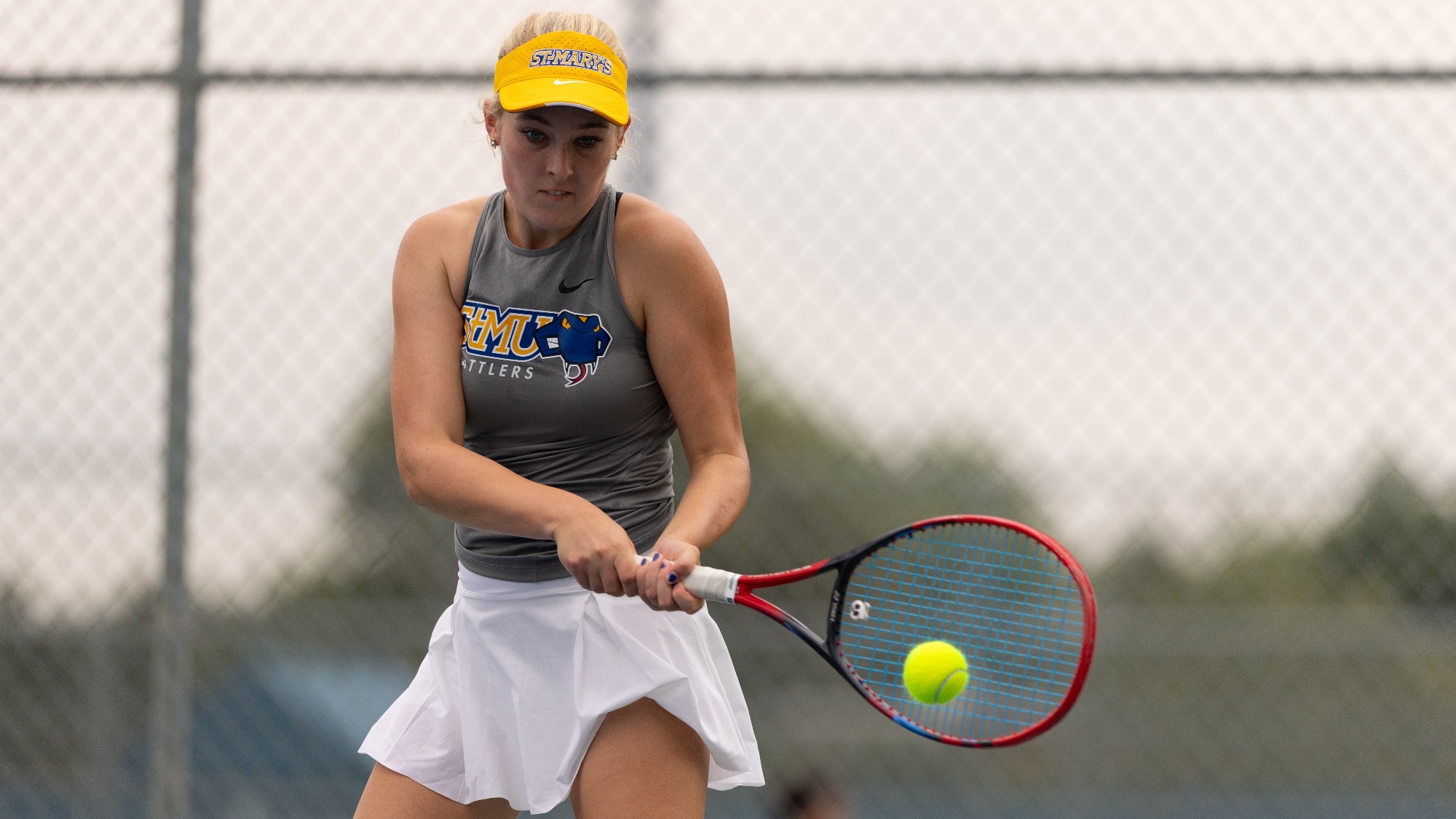 Isabella Olsson hits a two-handed backhand at the Brother Al Invitational.