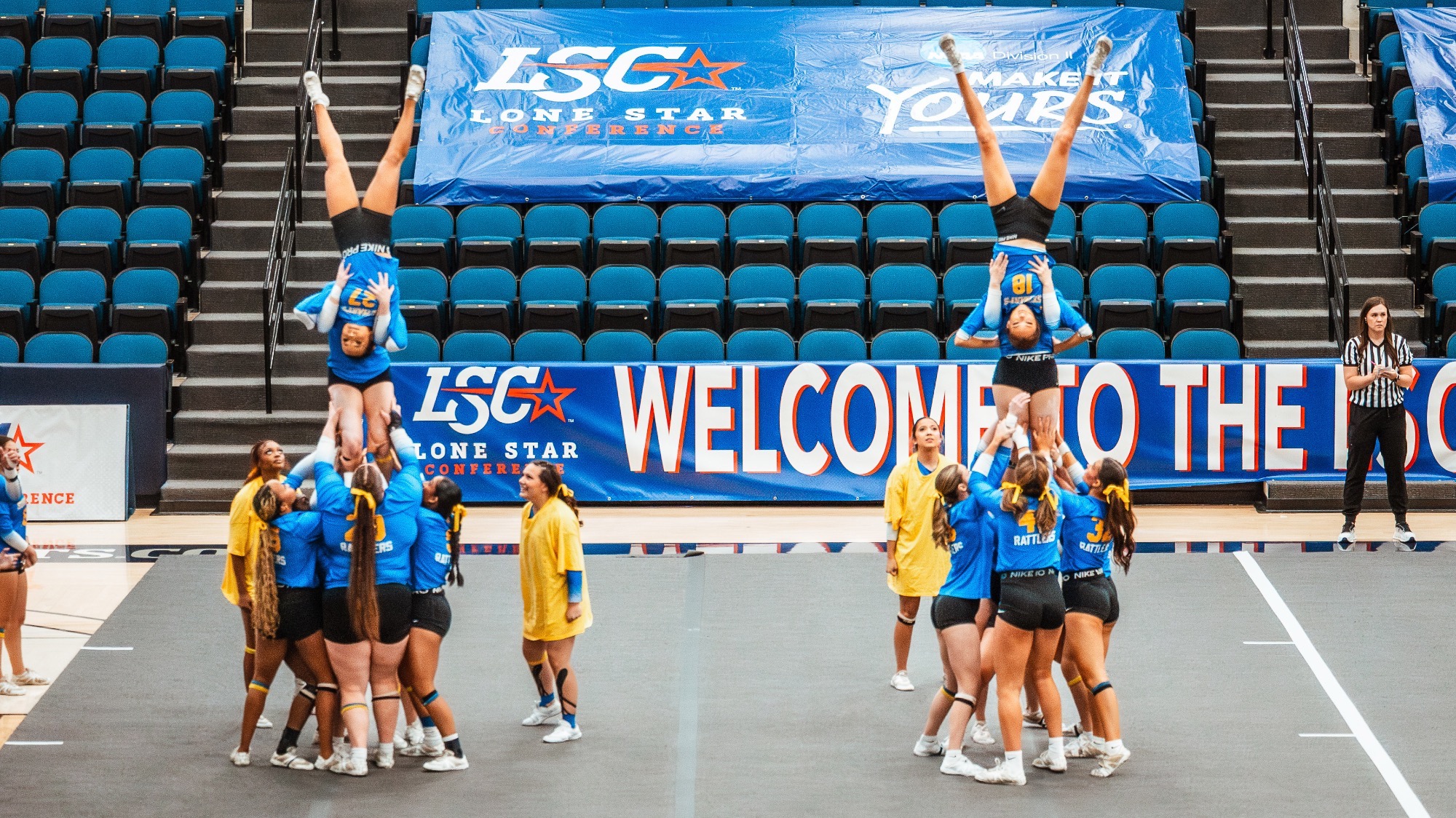 The STUNT team has two partner stunt groups with a player lifted, holding a teammate upside down.