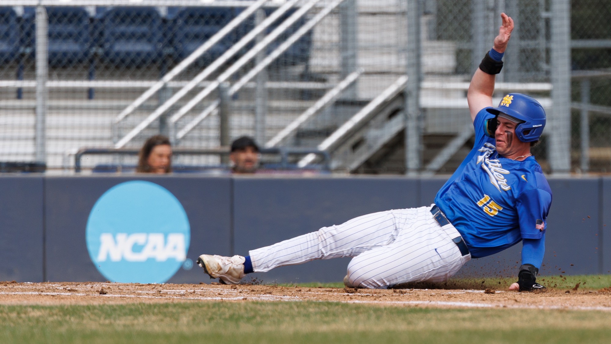 Garrett Brooks slides into home plate feet first