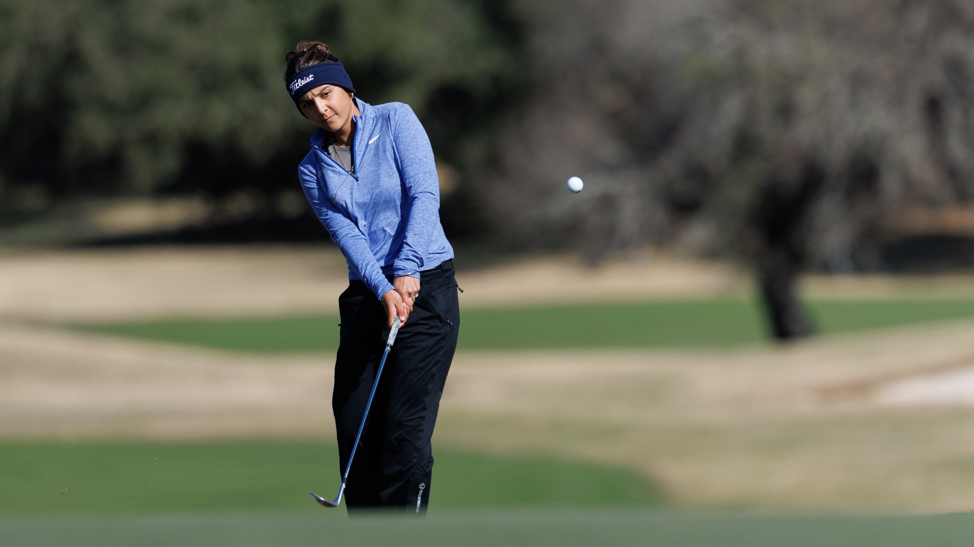 Manon Verret chips a shot onto the green at the Rattler Invitational